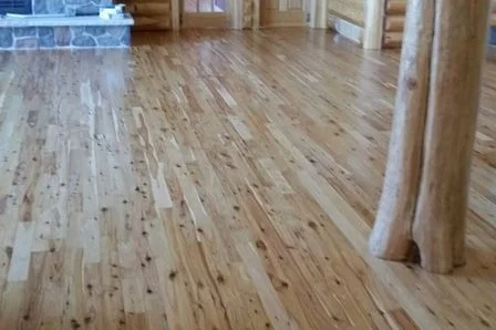 Polished wooden floor in a log cabin