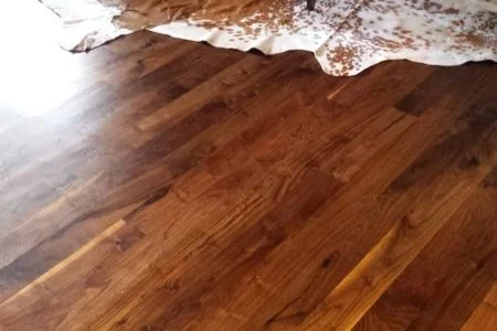 Wooden floor with a brown and white animal hide rug partially visible.