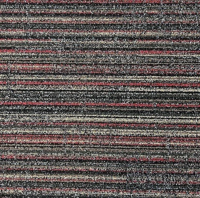 Textured carpet with horizontal stripes in red, black, and gray.