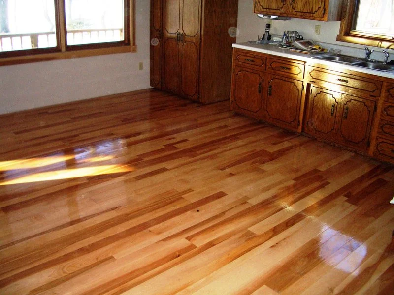 Kitchen with polished wooden floor and wooden cabinets