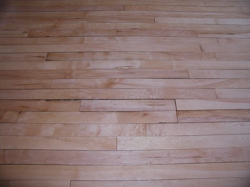 Close-up of hardwood flooring with natural wood grain and light finish.