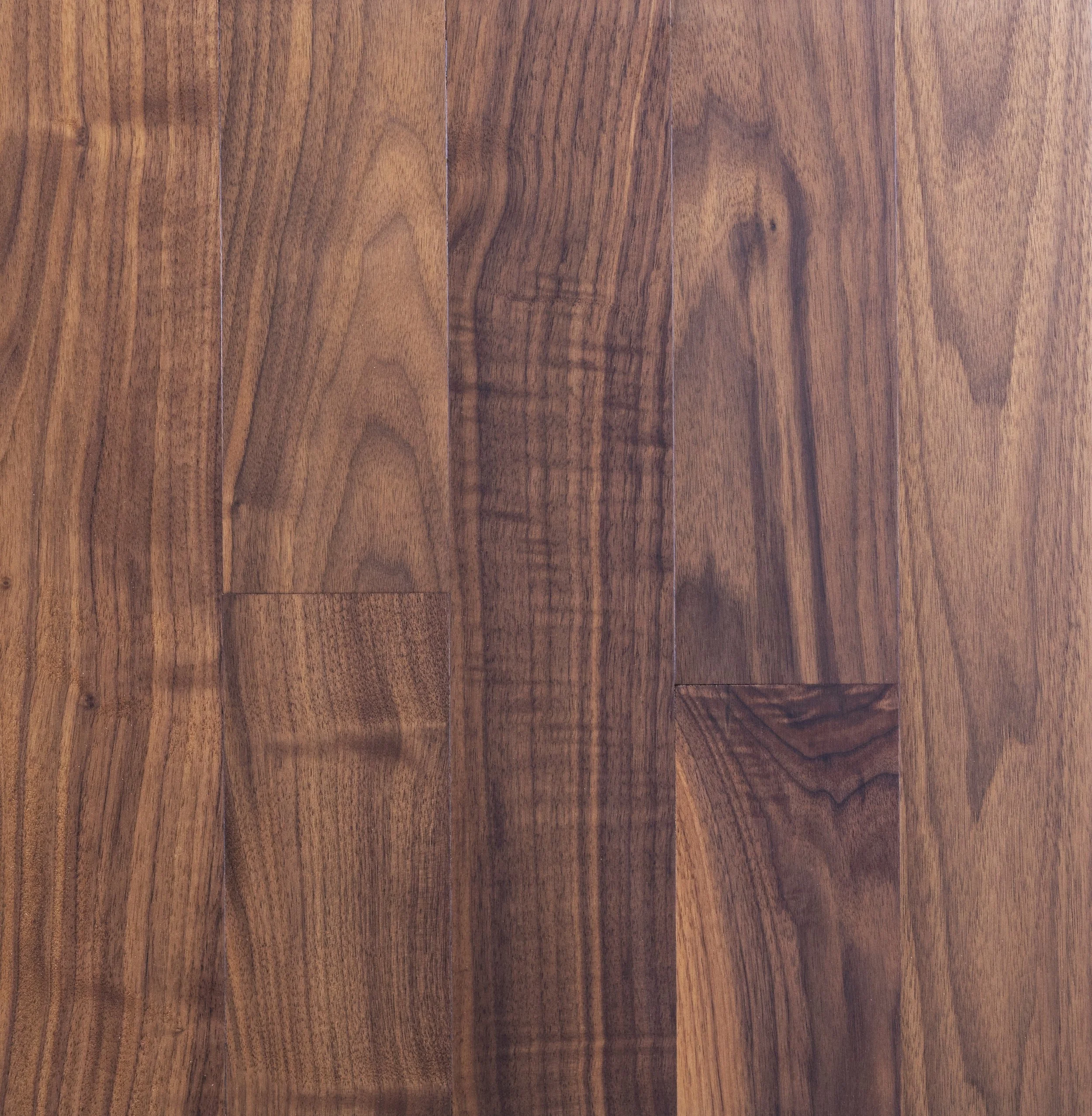 Close-up of walnut wood flooring with visible grain patterns and rich brown tones.