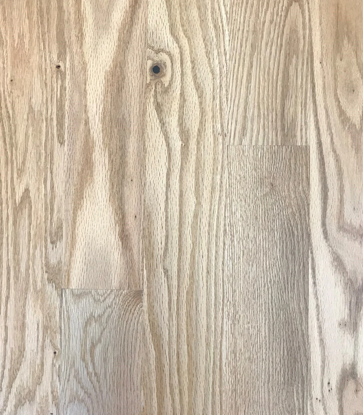 Light natural wood grain texture with visible knots and patterns.
