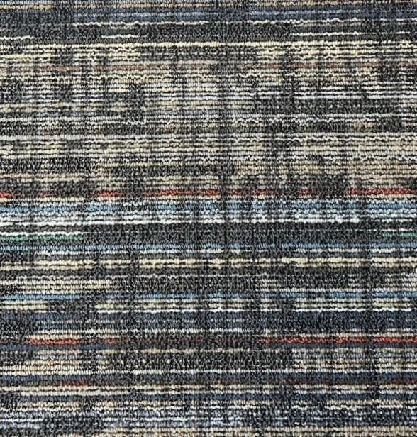 Close-up of a multicolored textured carpet with horizontal lines and patterns, featuring shades of gray, blue, brown, and red.