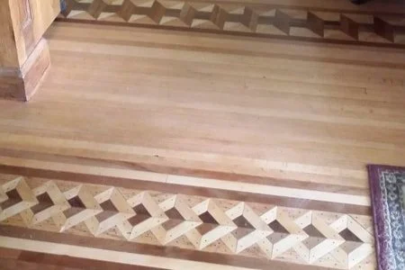 Wooden floor with geometric pattern inlay design