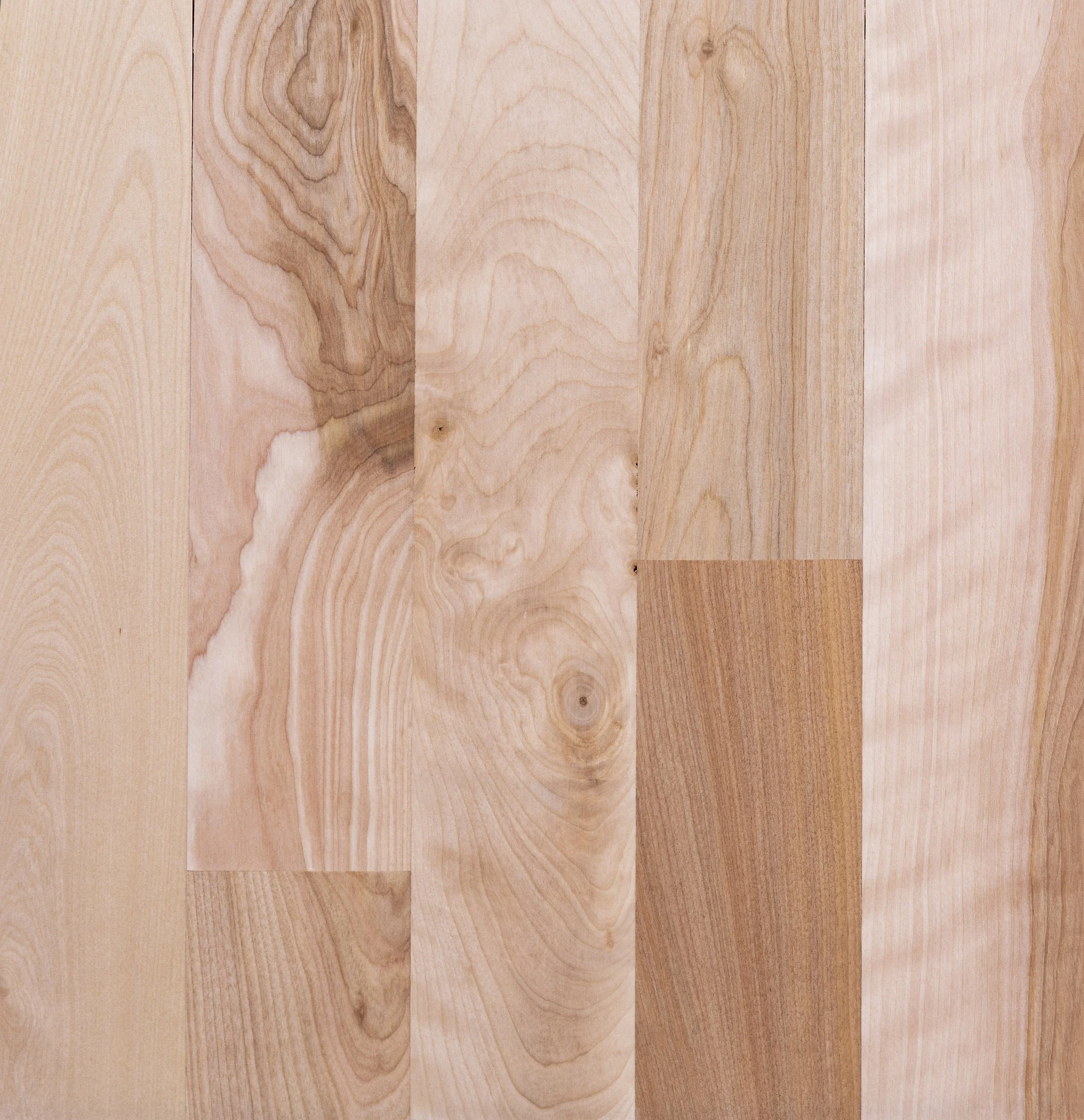 Close-up of light brown wood grain texture with variations and knots.