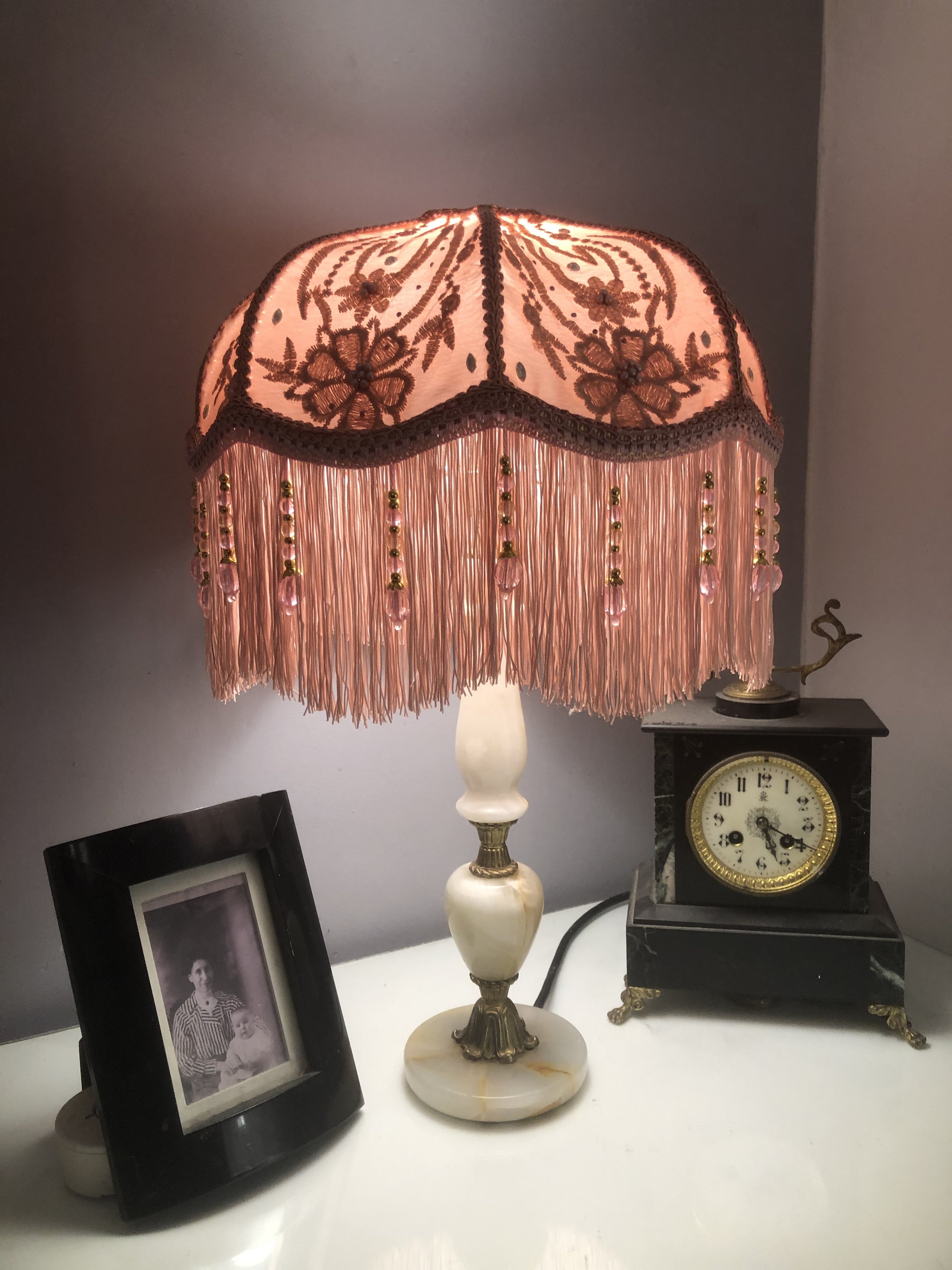Art deco fringed lampshade in pink silk and pink lace , floral detail lit up