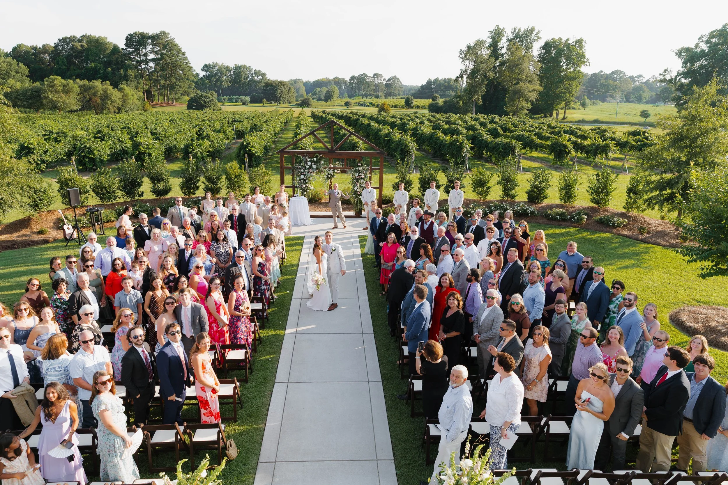 guests group photo of beautiful vineyard bride groom 