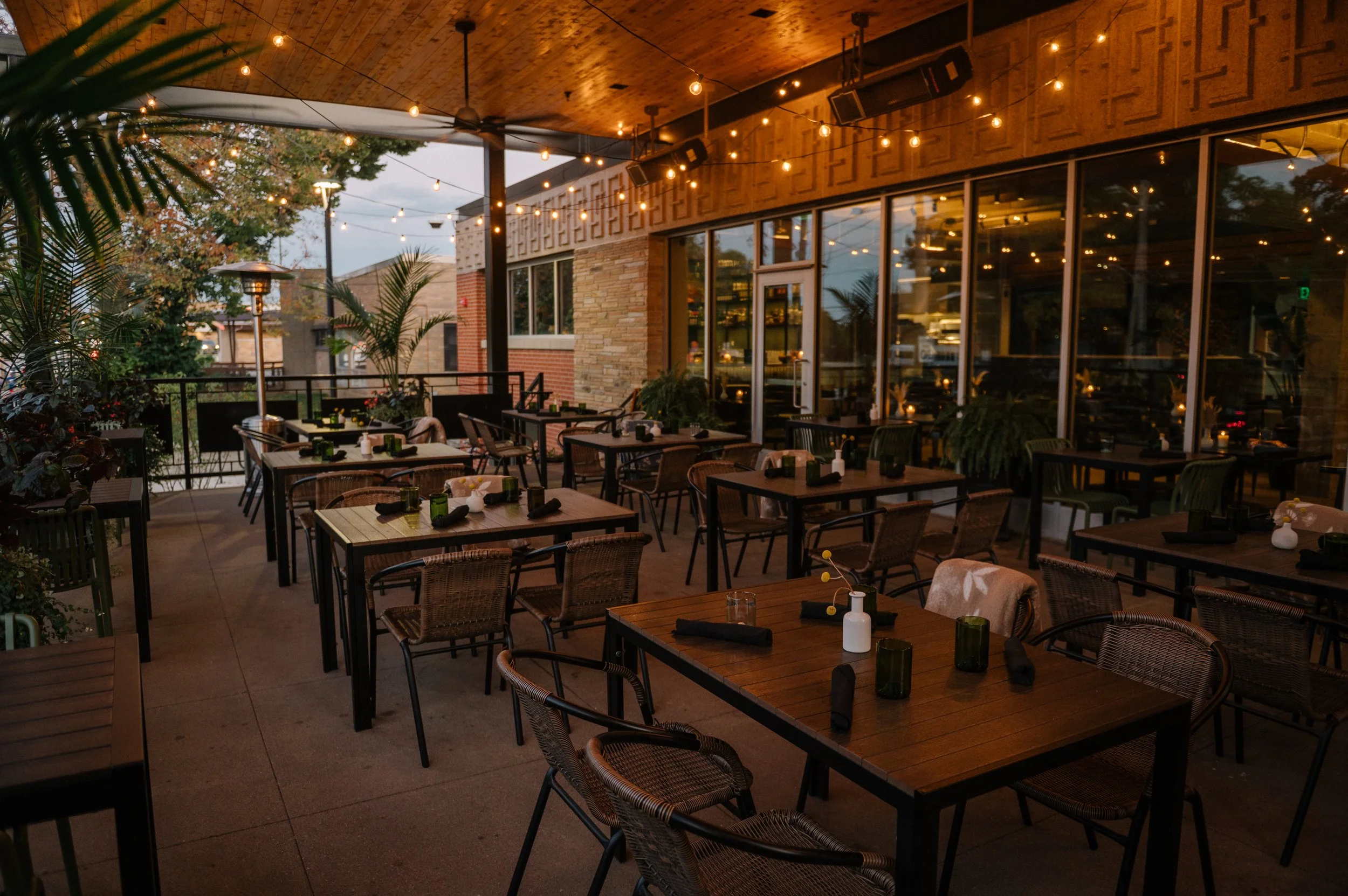Patio dining at Hugo’s during sunset in the Drake neighborhood.