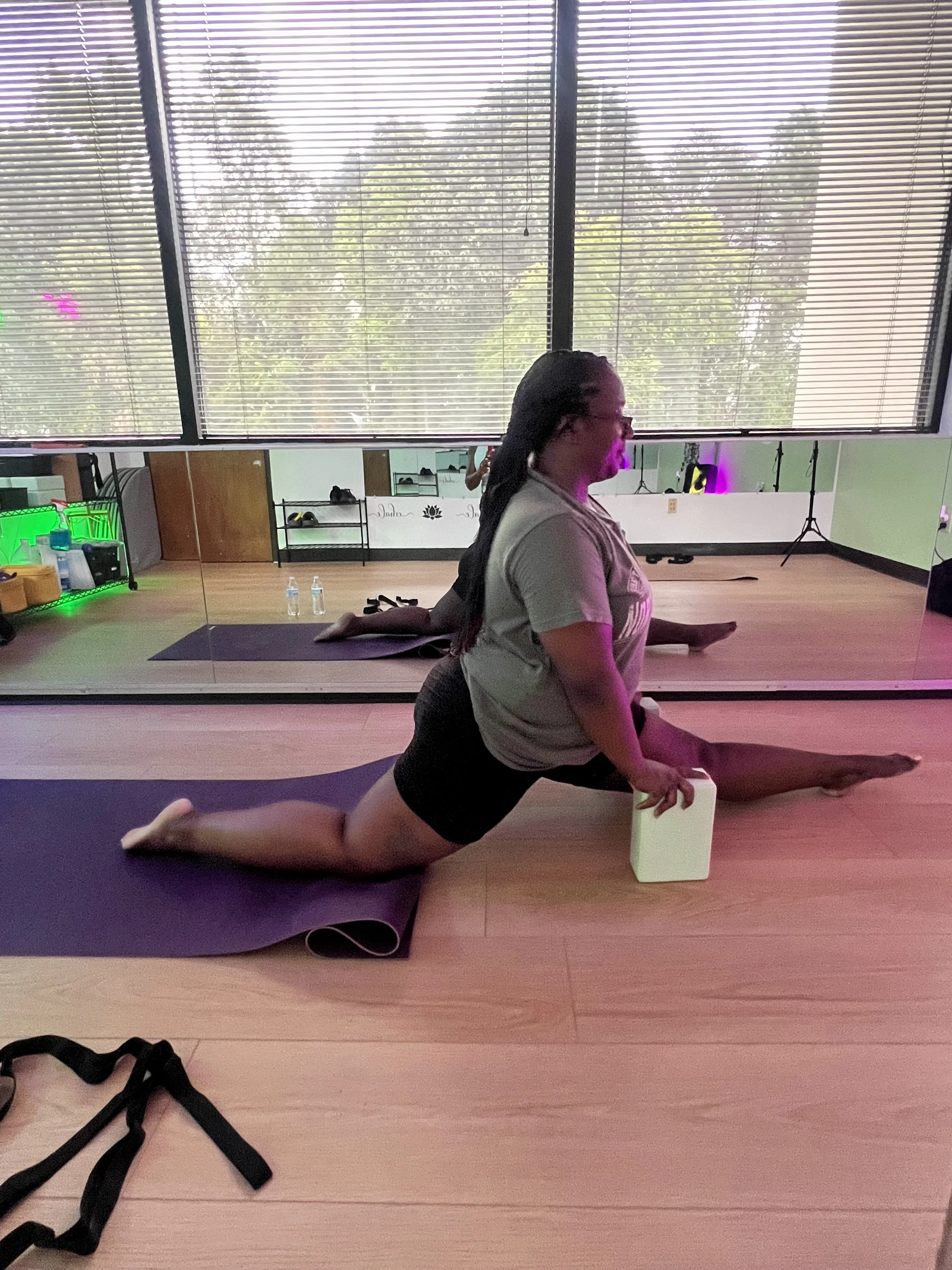 Woman taking a private pole fitness lesson at The Twirl Girls Fitness Club in Greensboro NC