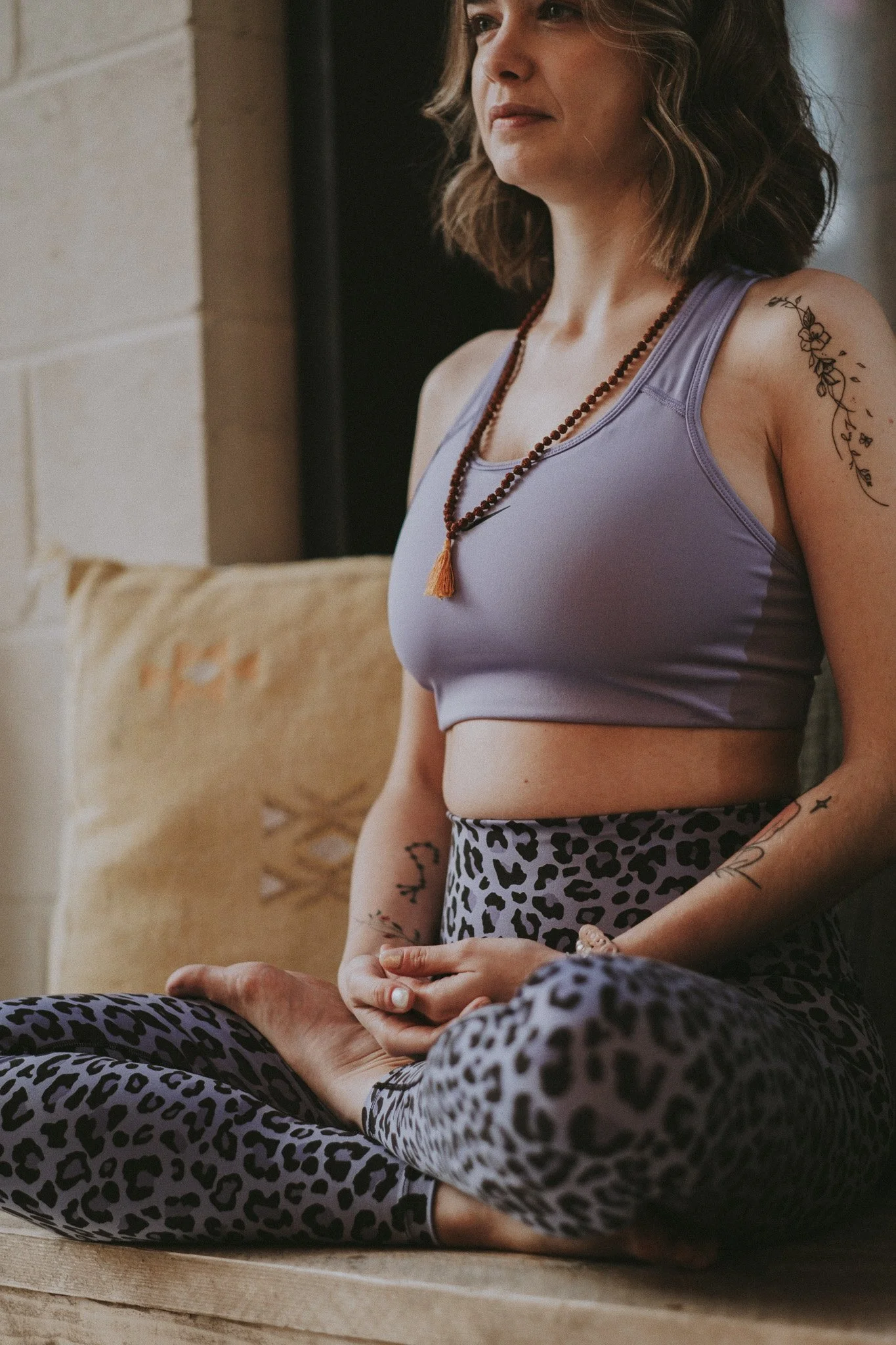 Catarina sitting crossed legged in meditation and hands in her lap