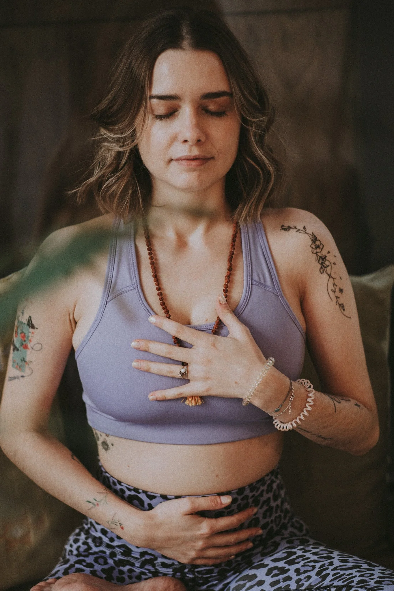 Catarina with her hands on her heart and belly breathing consciously