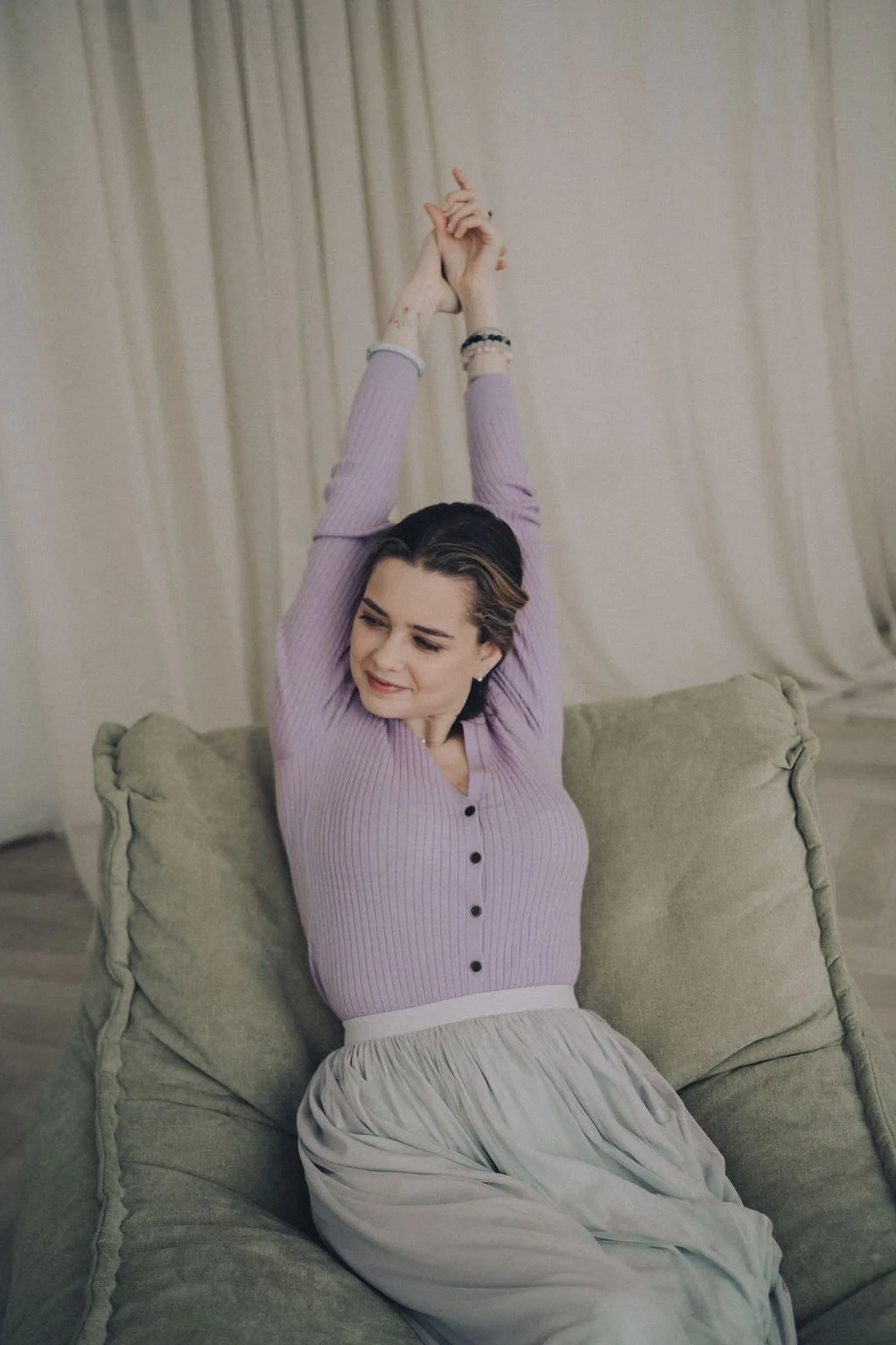 Catarina sitting stretching her arms out and smiling