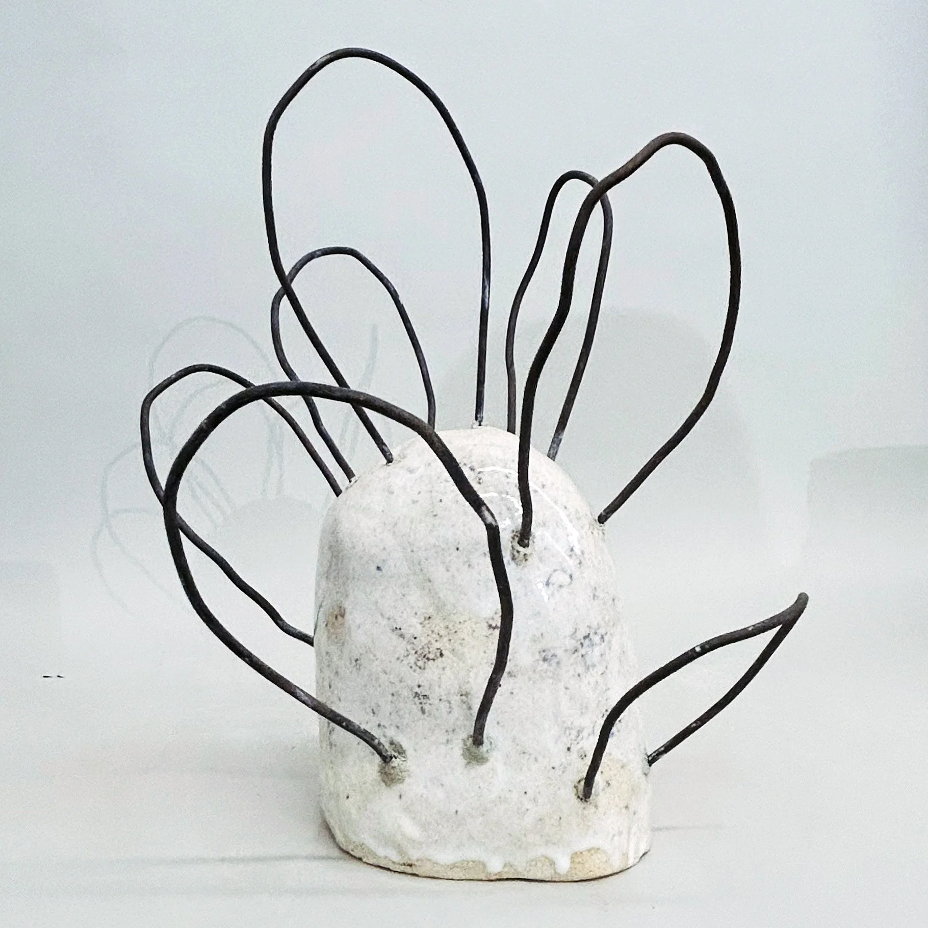 Untitled, 2023, ceramic and metal, 1.5 x 12 x 12 inches