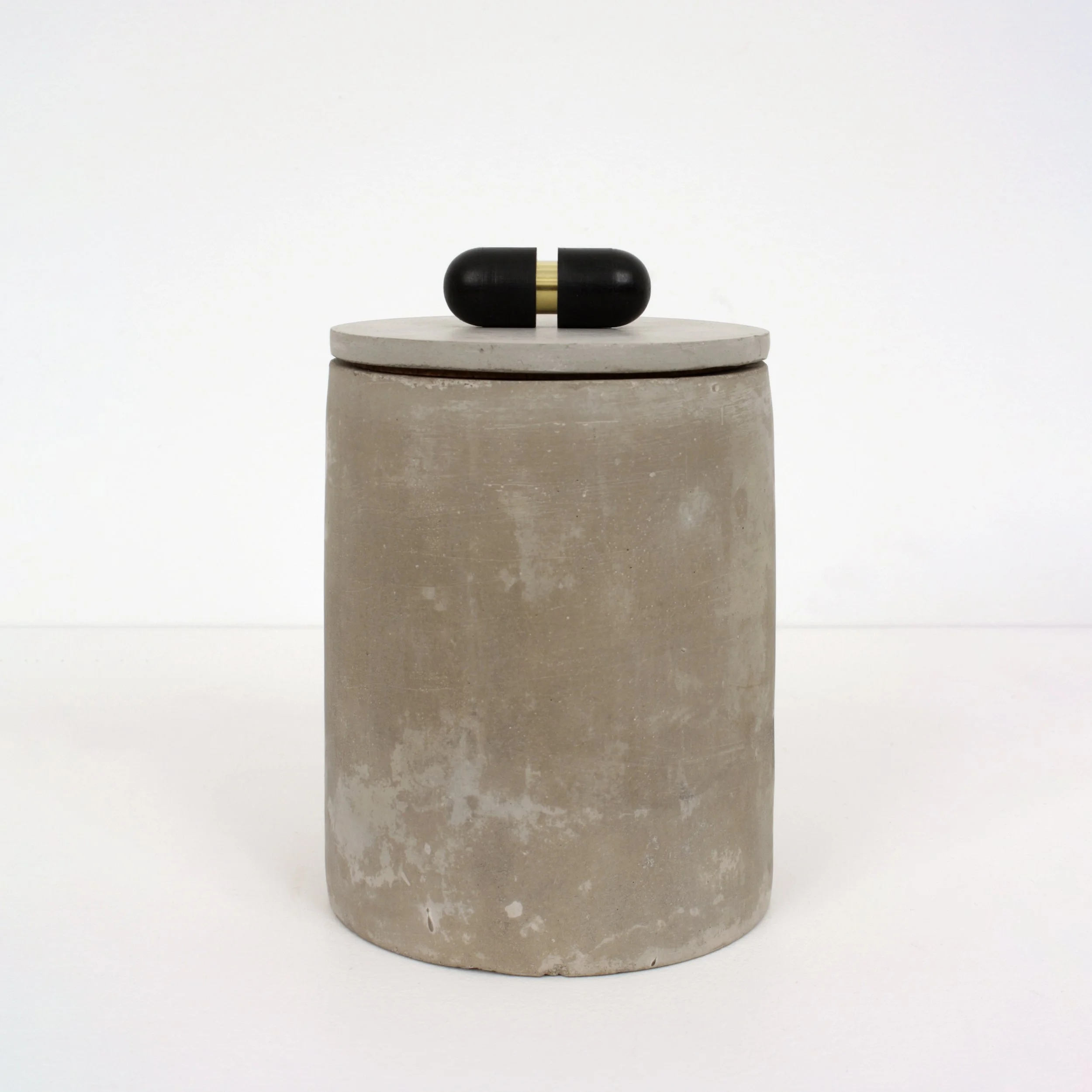 Capsule, Found rubber, brass, and concrete objects, 6 x 4 x 4 inches