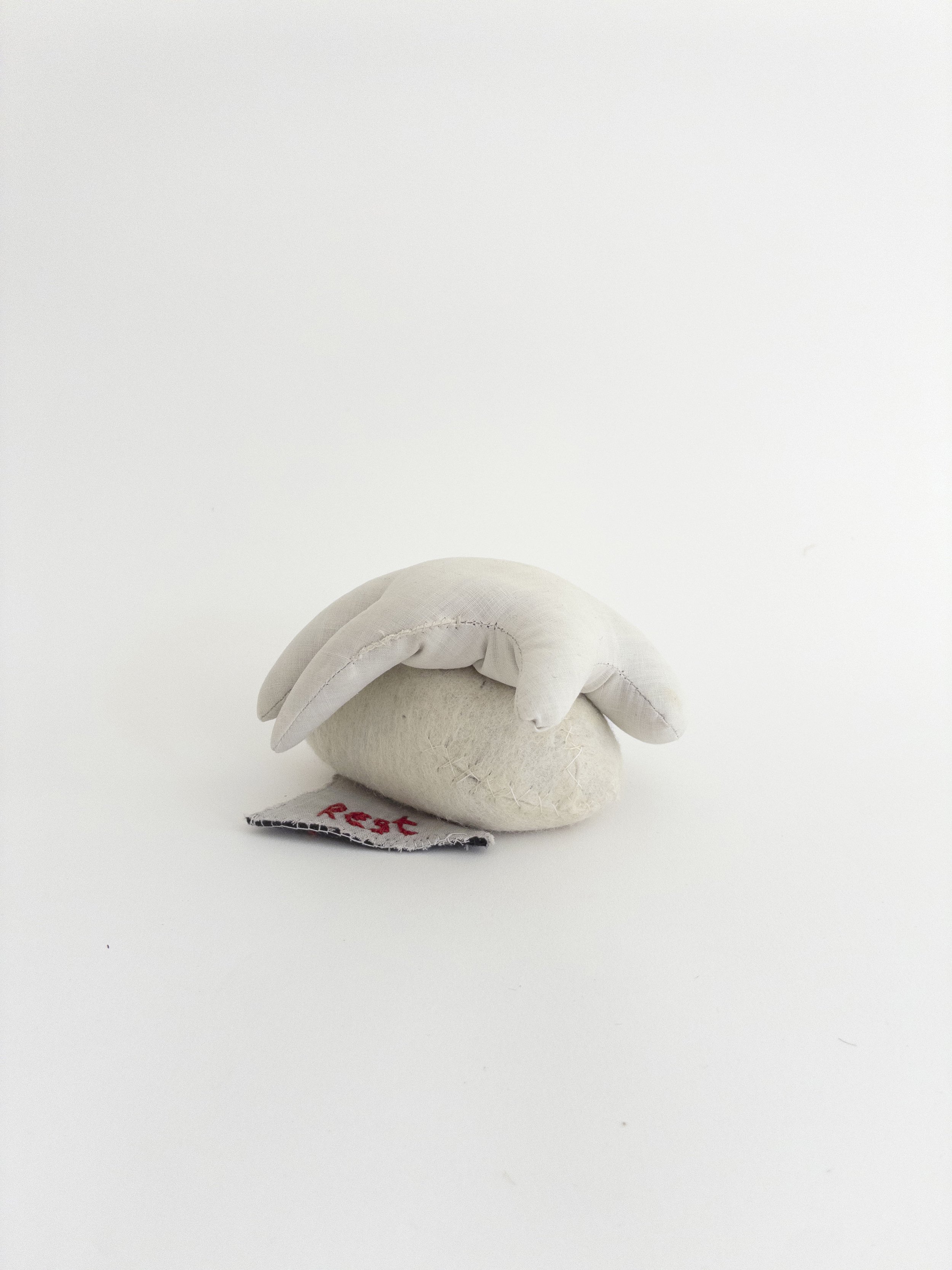Rest, 2003-2026, sand, cotton, wool, 4.5 x 3 inches