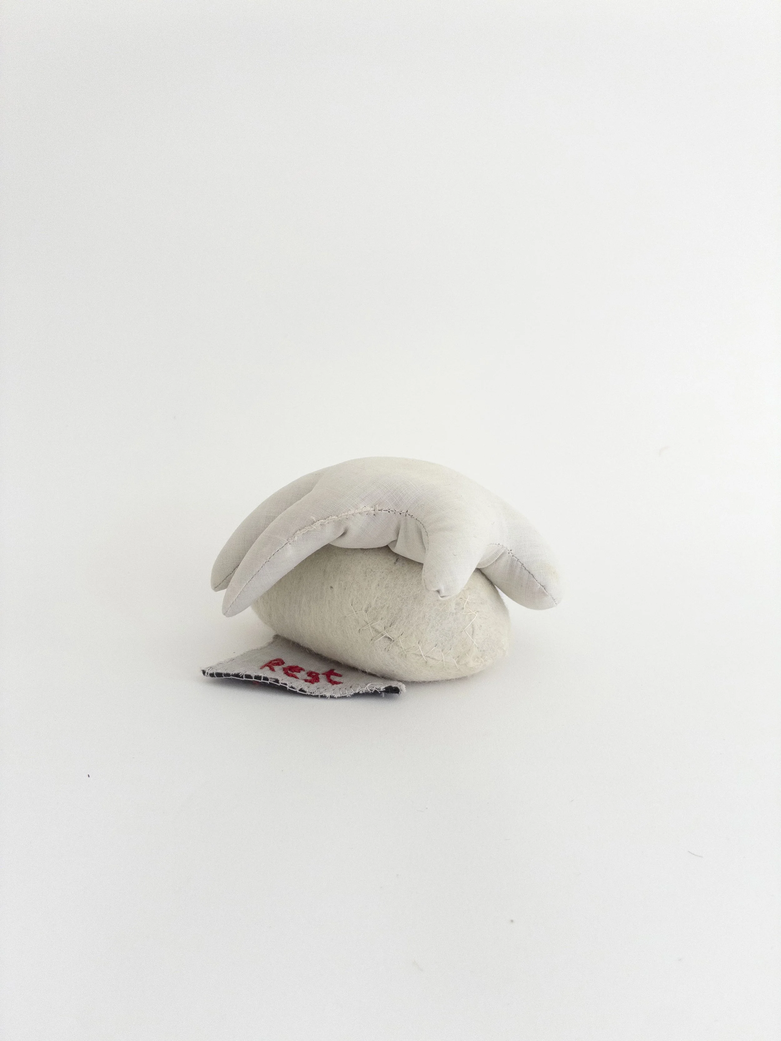 Rest, 2003-2026, sand, cotton, wool, 4.5 x 3 inches