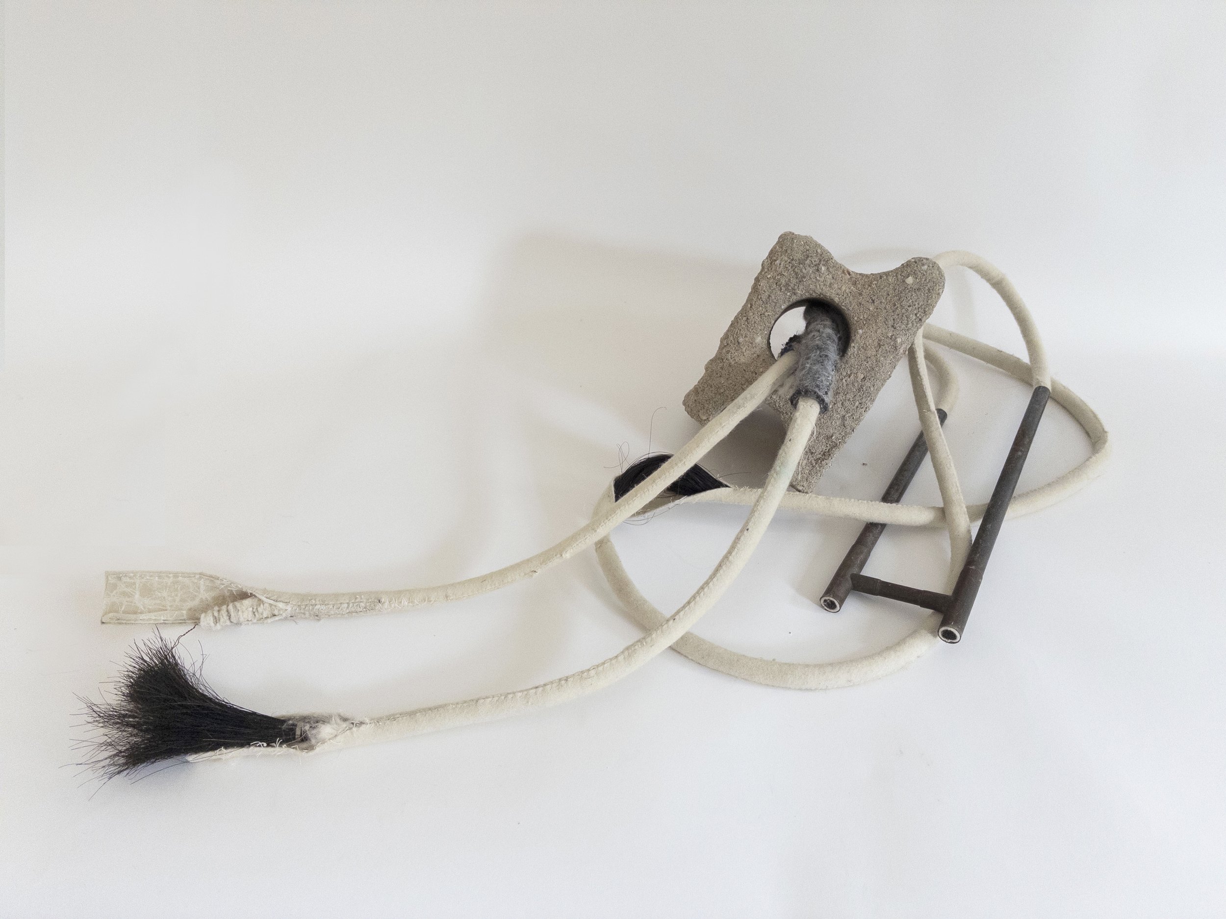 Sounding, 2026, cement, wool, metal, cotton, horsehair, wax, 8 x 46 x 19 inches,