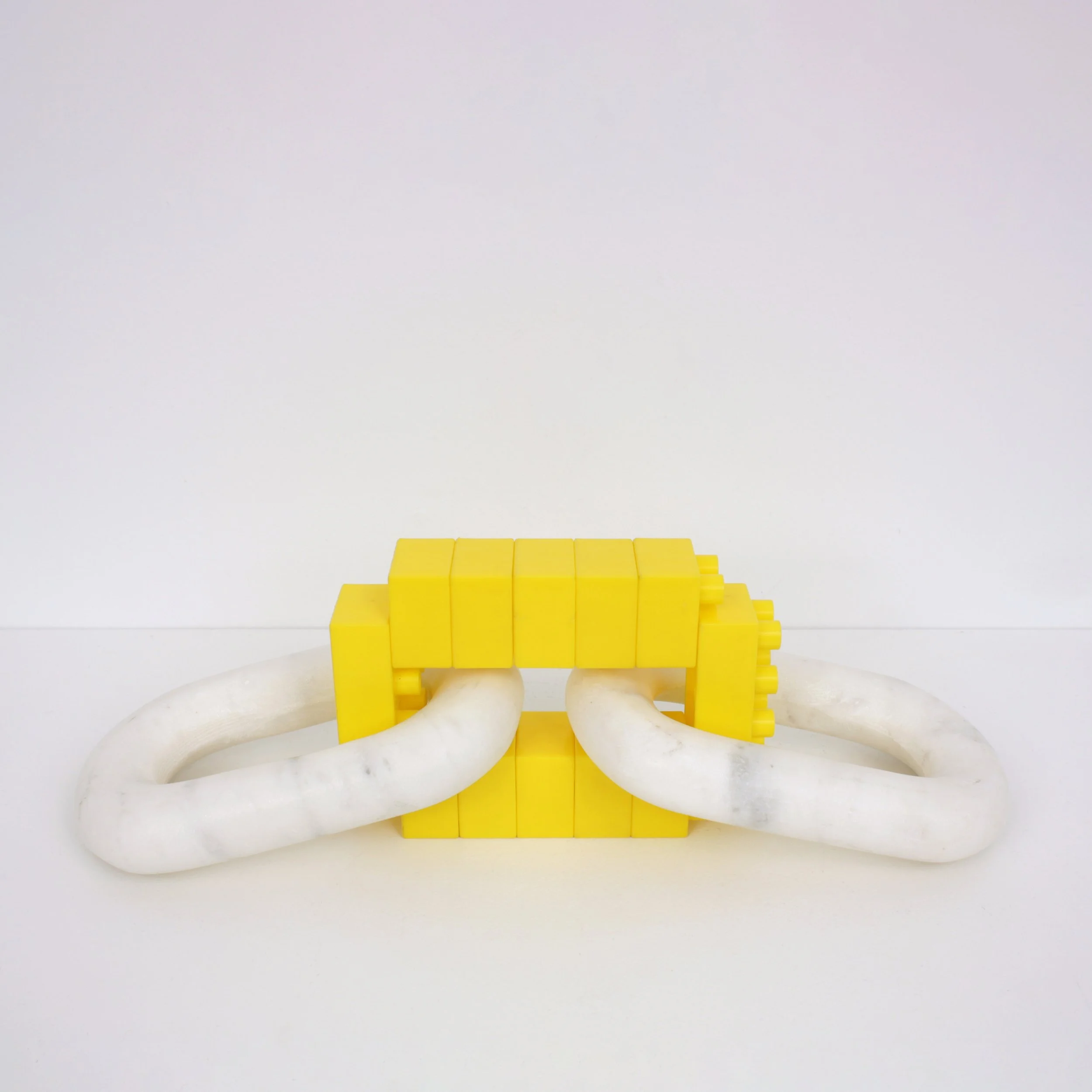 Missing Link, 2023, Found marble and plastic objects, 3.75 x 12.5 x 4 inches