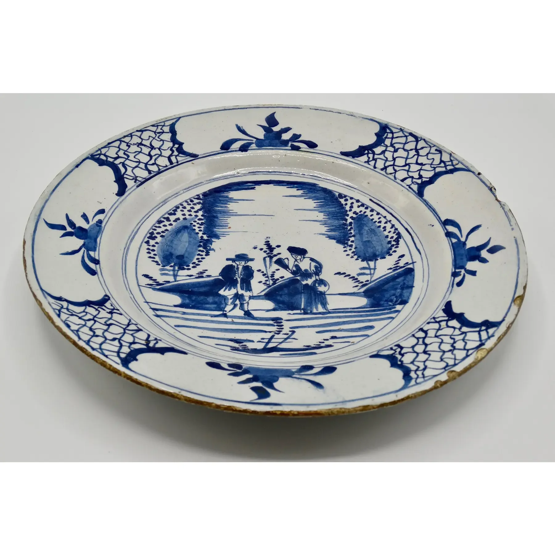 Side profile of antique Dutch Delft blue and white charger.