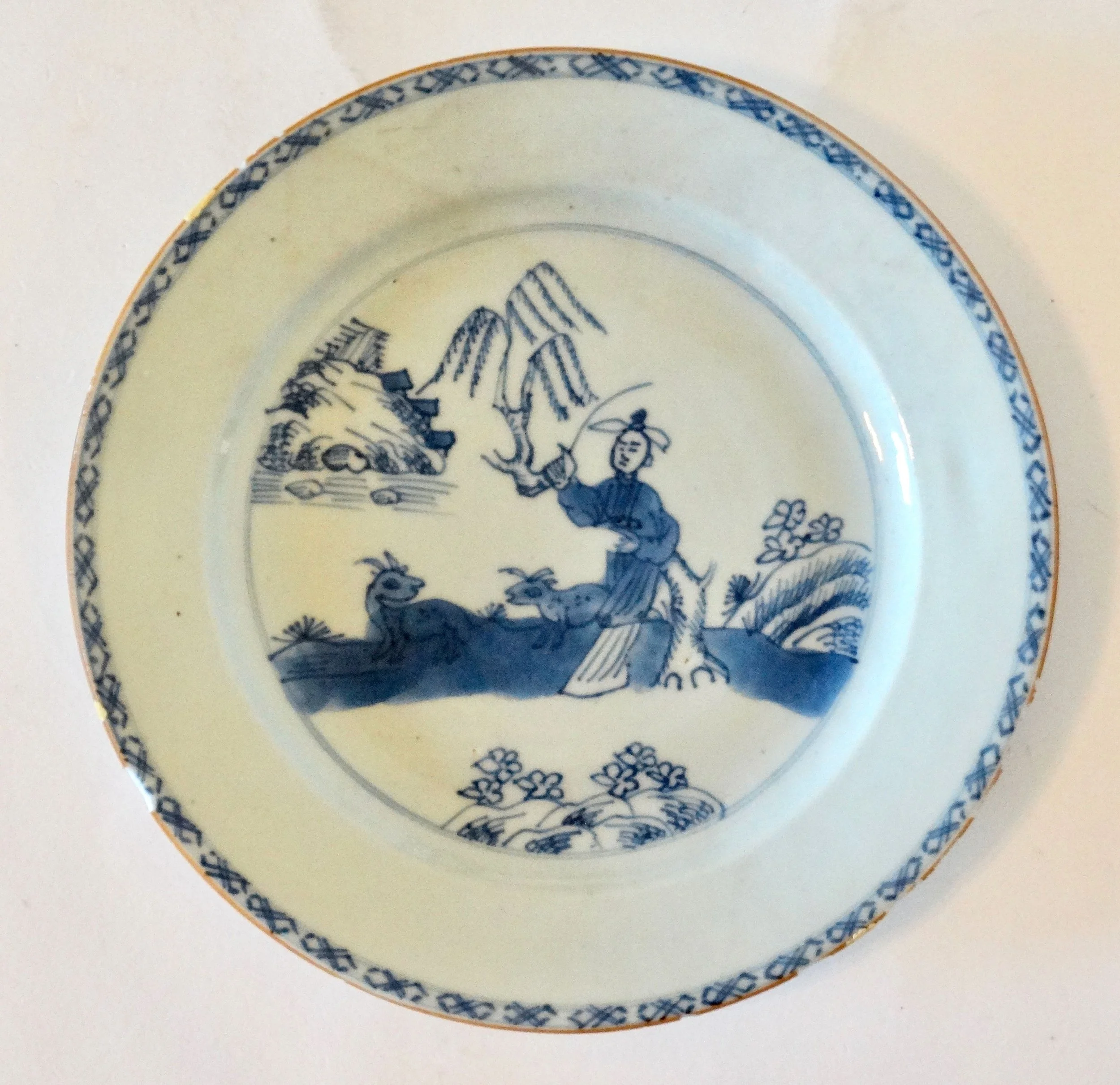 18th-century English Delftware chinoiserie plate, hand painted figure and animals, floral geometric border