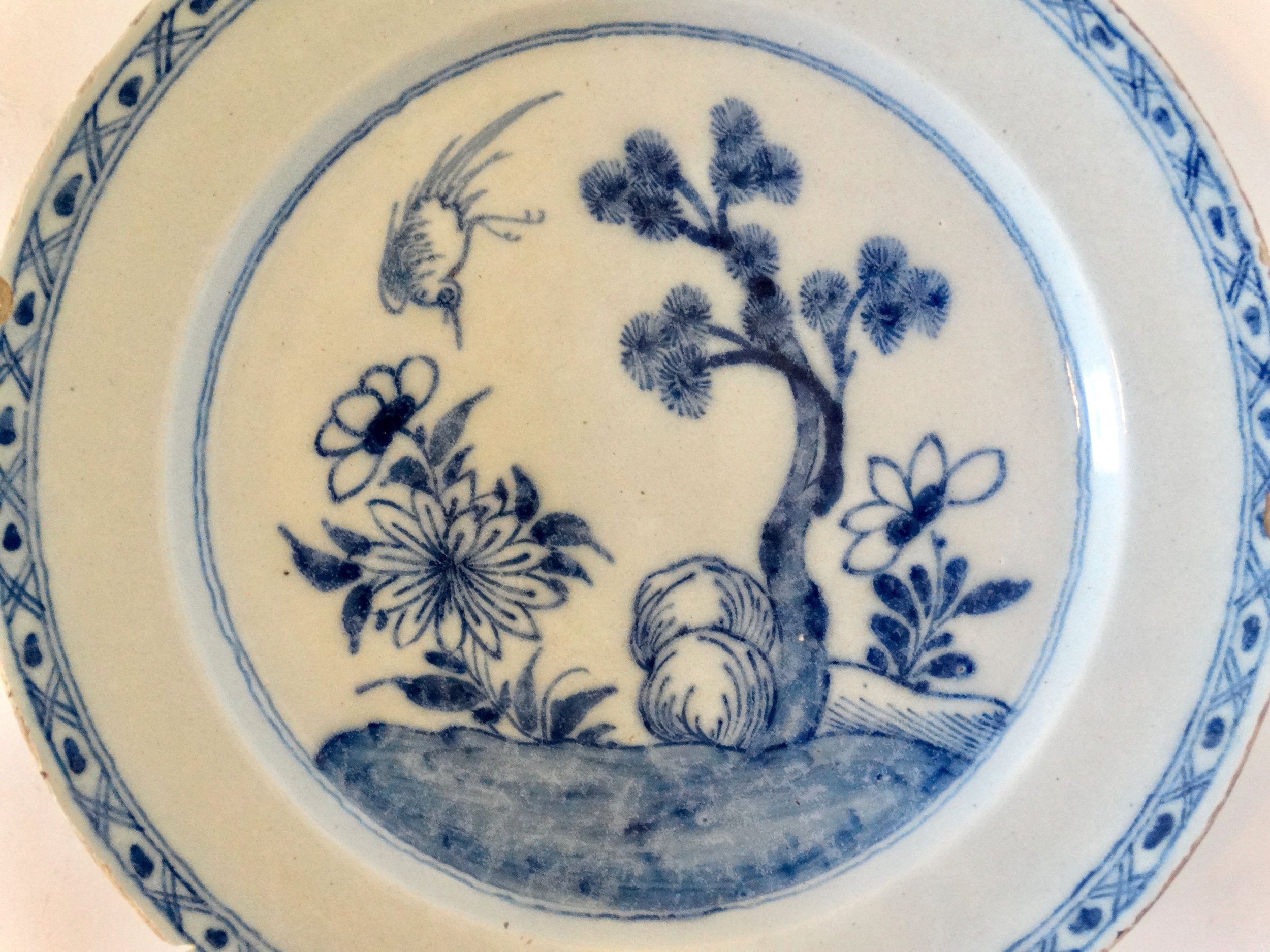 Hand painted floral and tree motif on antique Delft charger.