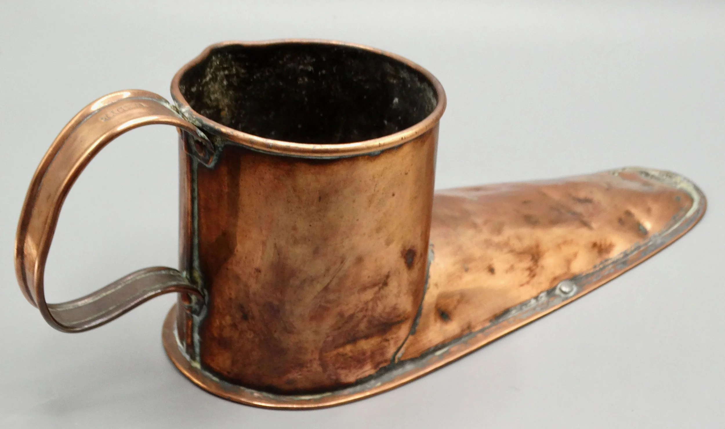 Back of 19th-century English copper boot ale warmer, showing hand formed copper craftsmanship