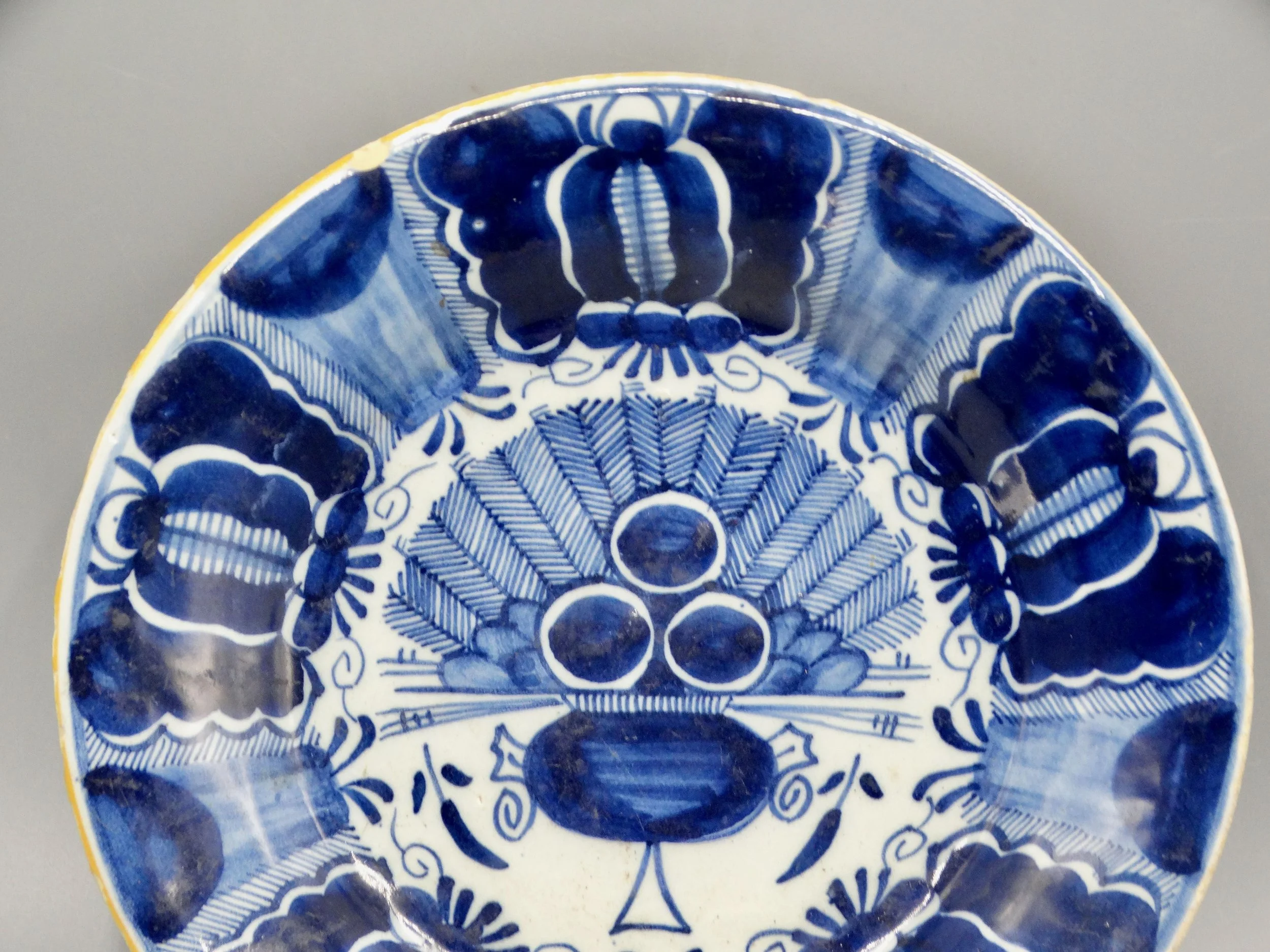 18th-century Dutch Delftware peacock plate, hand painted in blue and white, ochre rim, Three Bells maker mark