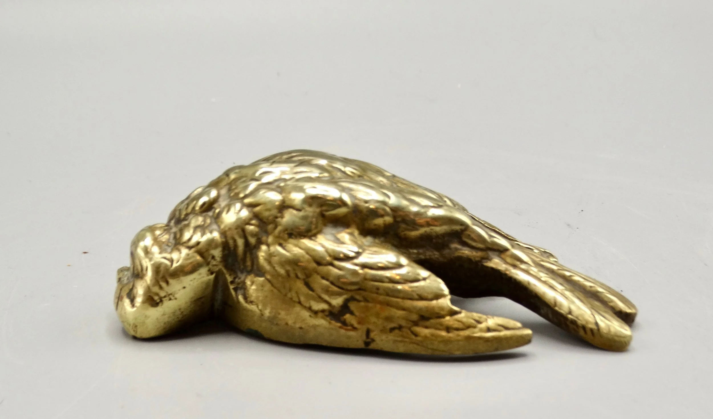 Gilt bronze sparrow sculpture attributed to Paul Comoléra, finely cast with lying pose and patina.