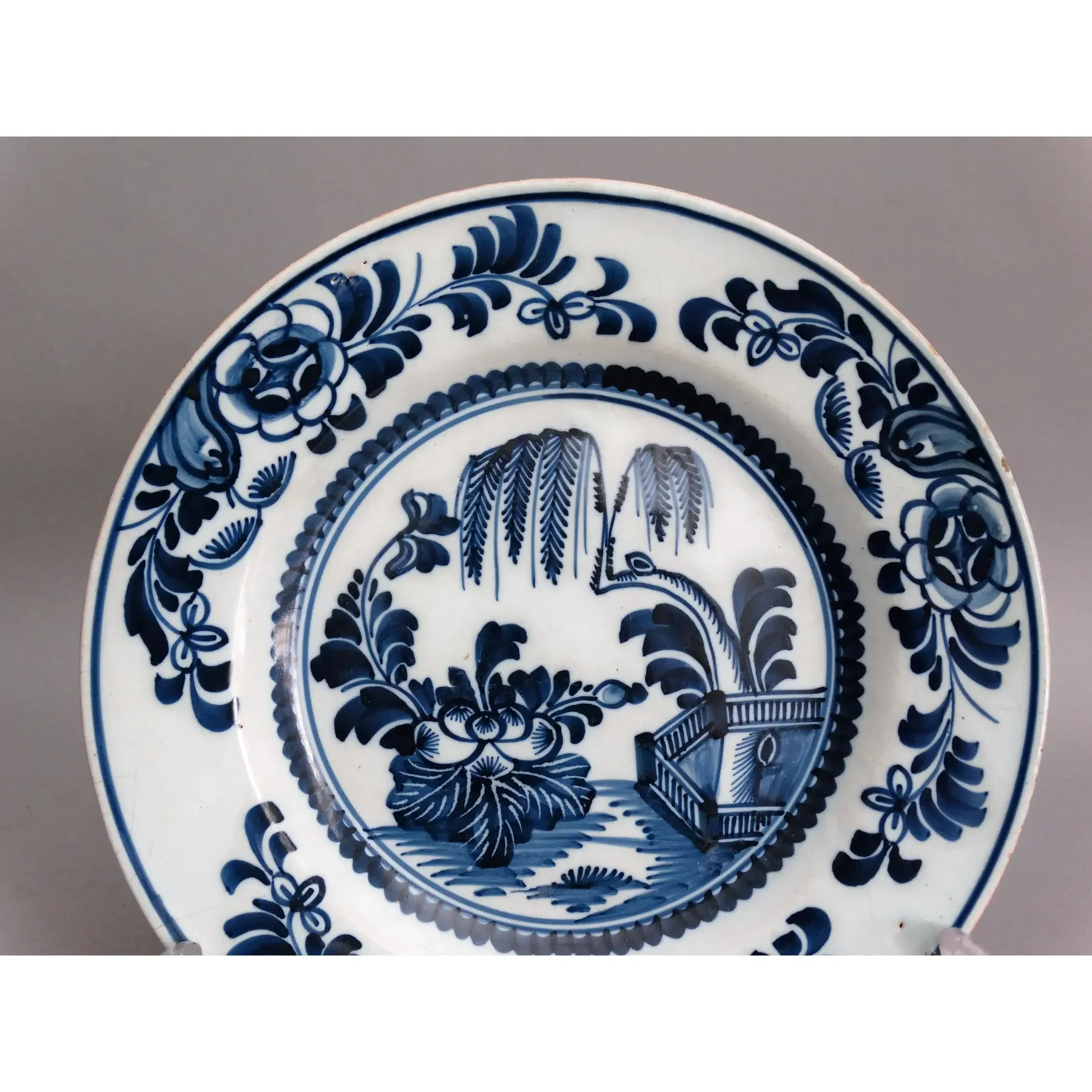 Willow tree landscape on antique 18th century Delft chinoiserie plate.