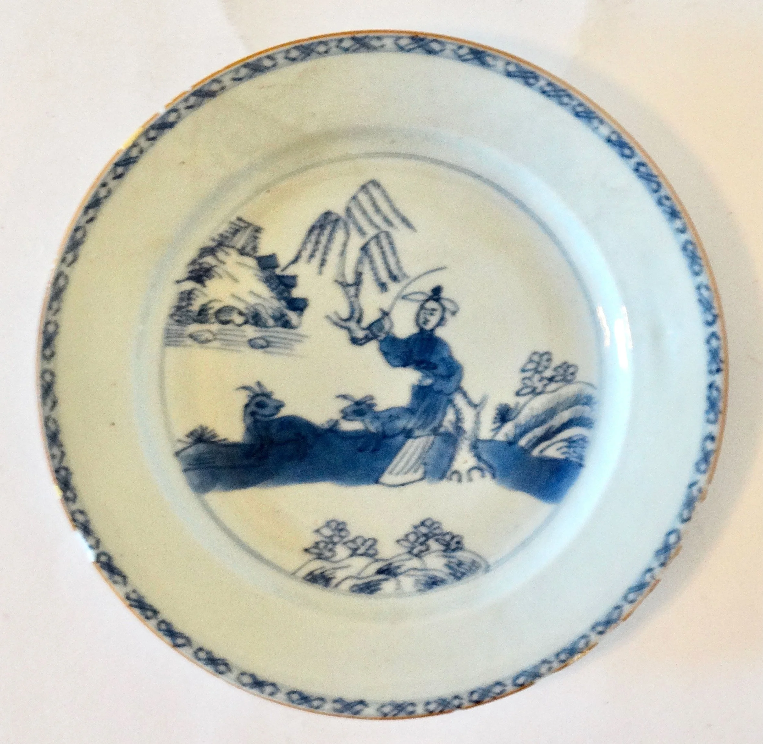 18th-century English Delftware chinoiserie plate, hand painted figure and animals, floral geometric border