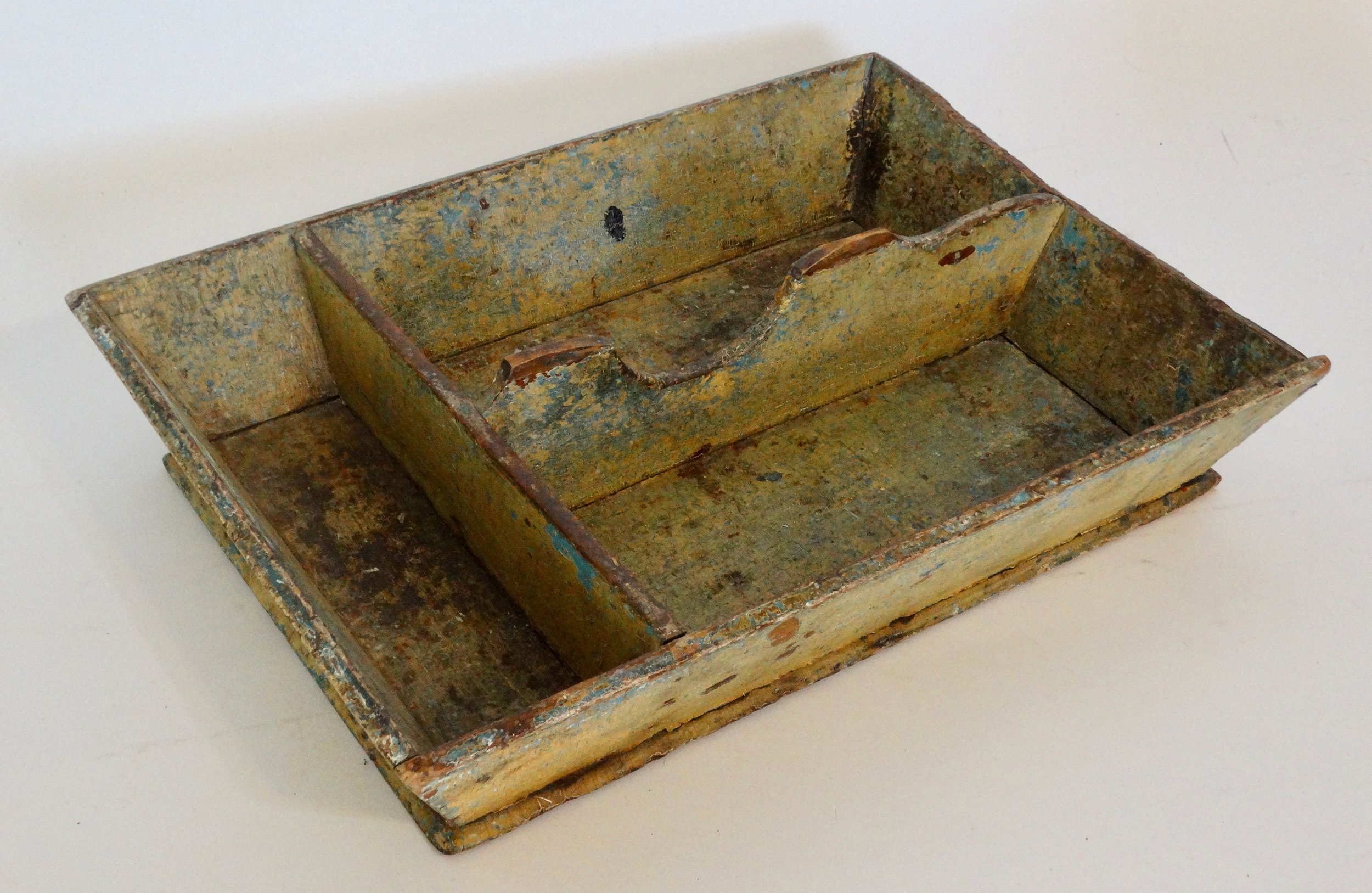 Early 19th-century American primitive cutlery tray in mustard colored paint with canted sides and protruding base.