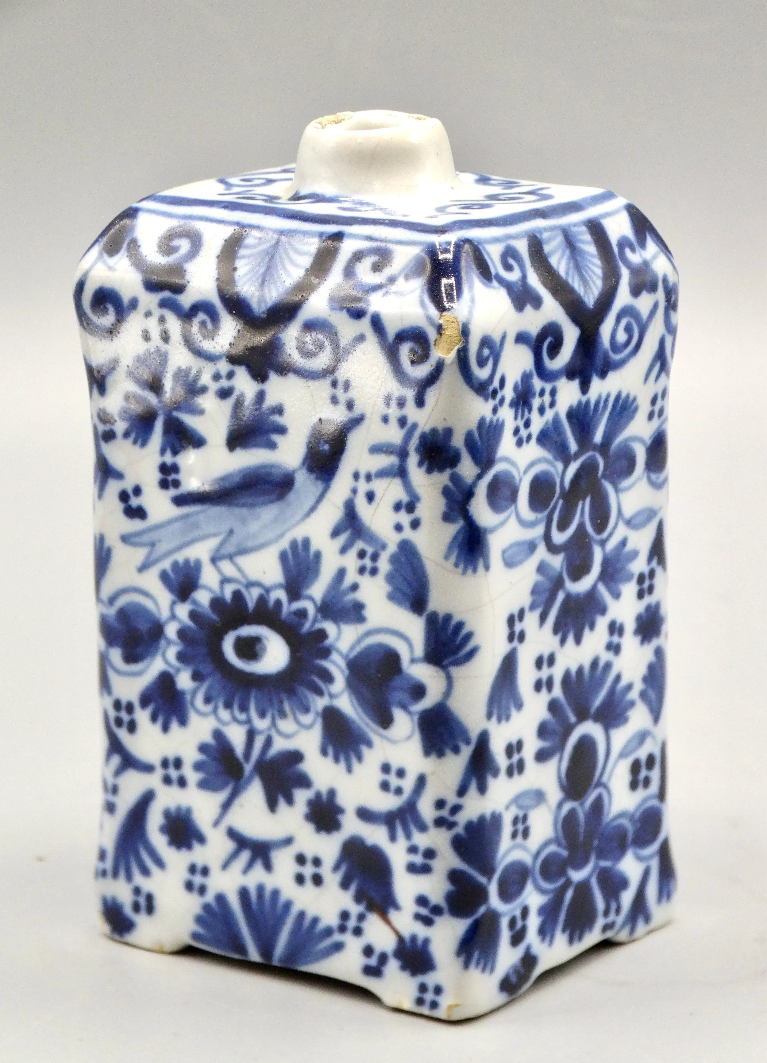 19th-century English Delft tea caddy with hand painted rampart lions, crown coat of arms, bird, and floral motifs.