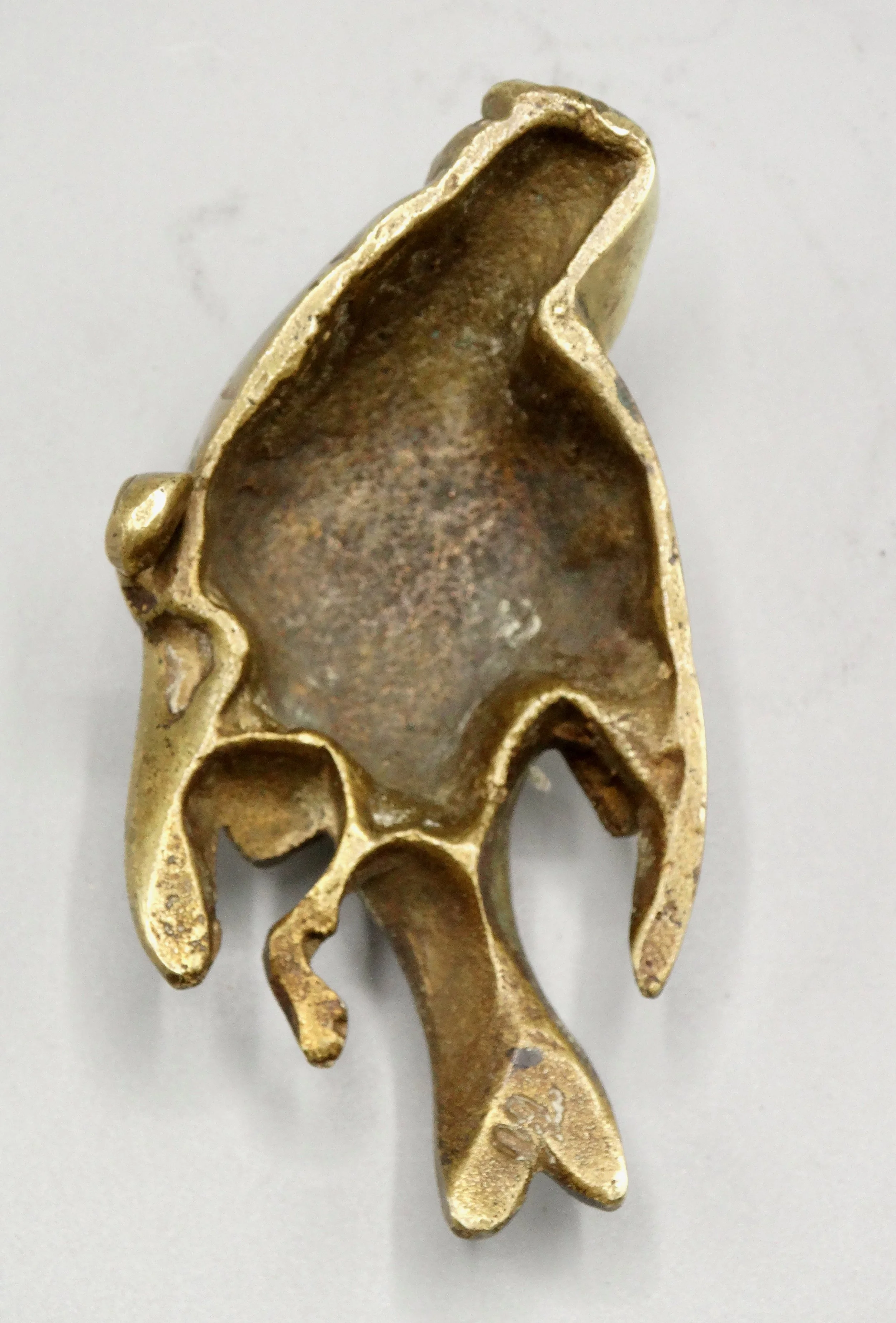 Underside of gilt bronze sparrow sculpture showing artist’s mark on tail attributed to Paul Comoléra.