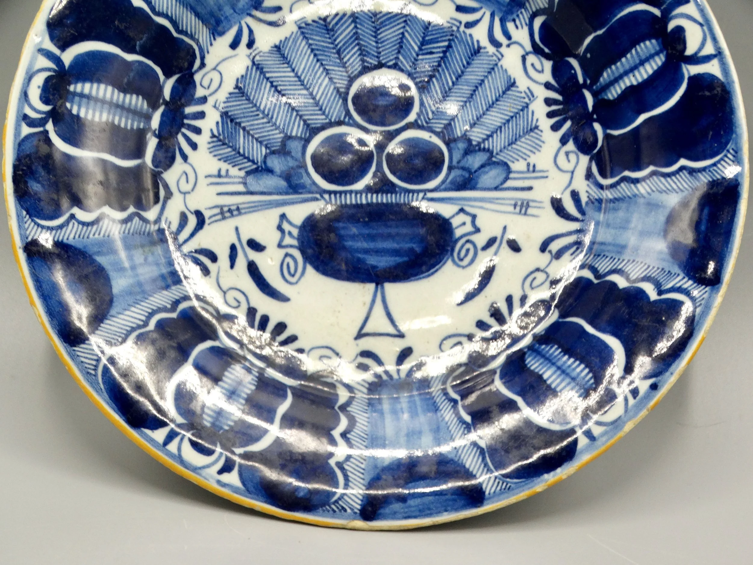 18th-century Dutch Delftware peacock plate, hand painted in blue and white, ochre rim, Three Bells maker mark