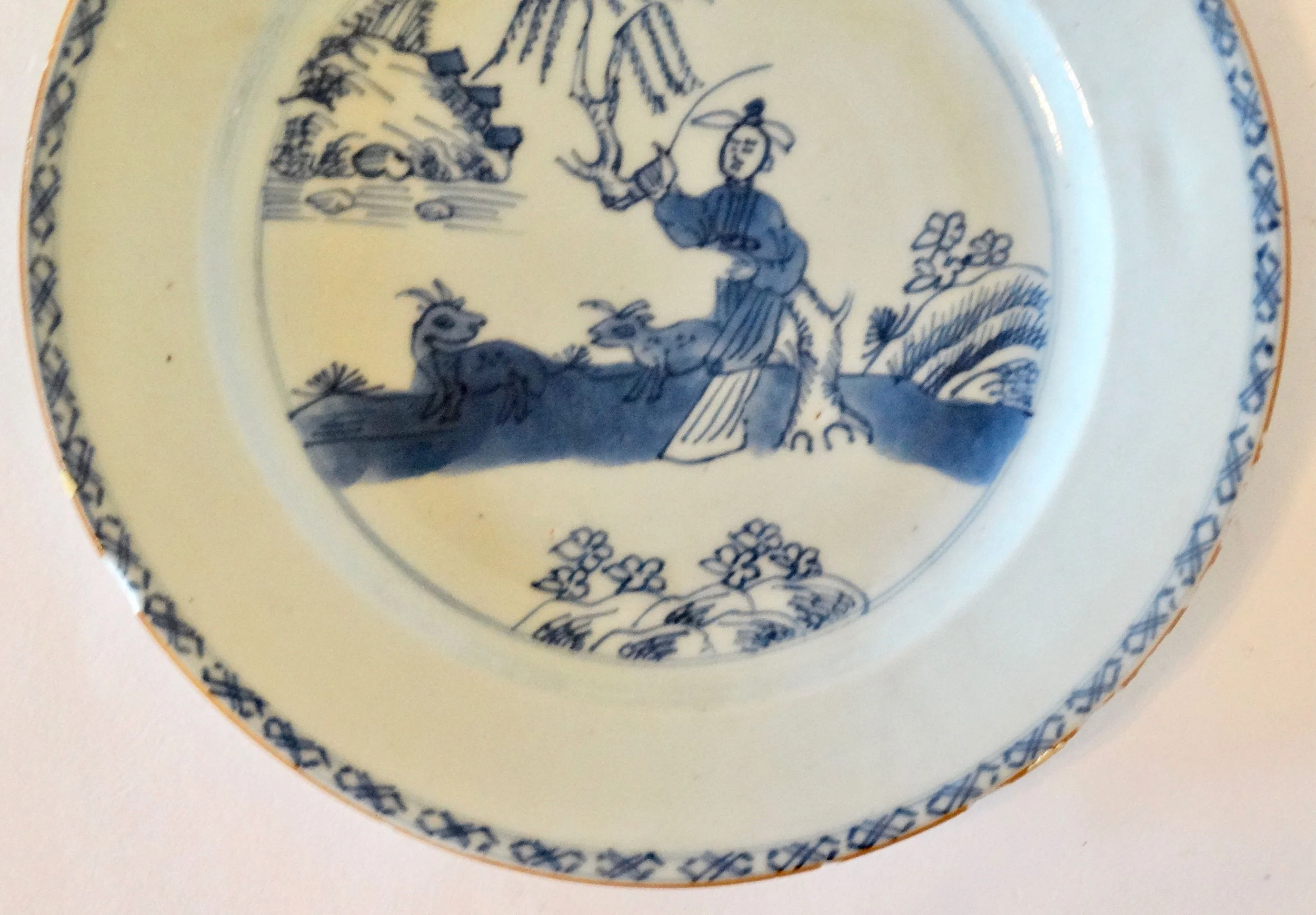 Floral and geometric border detail on 18th-century English Delftware chinoiserie plate, hand painted