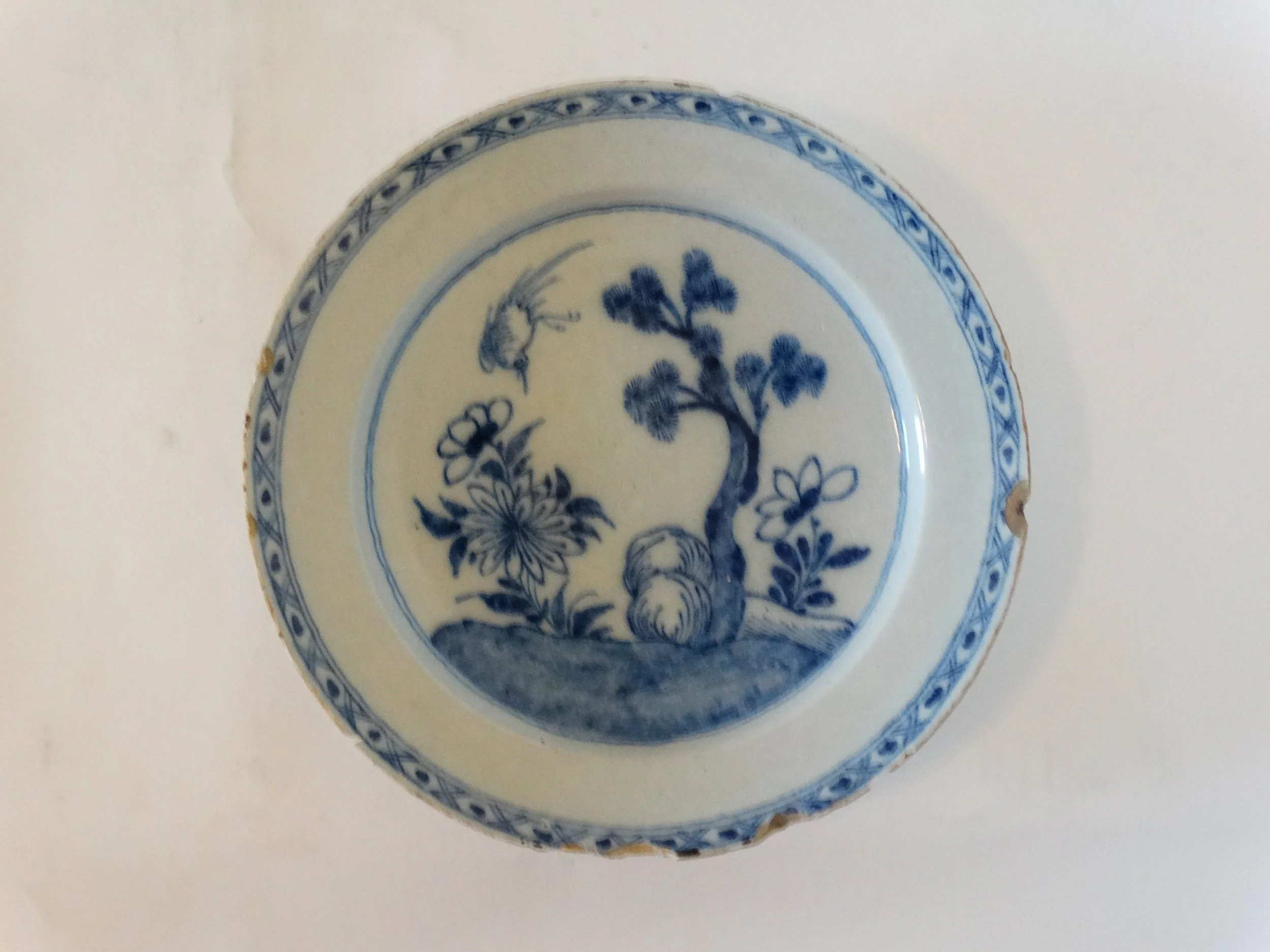 Large antique Delft chinoiserie charger with hand painted blue floral and tree design.