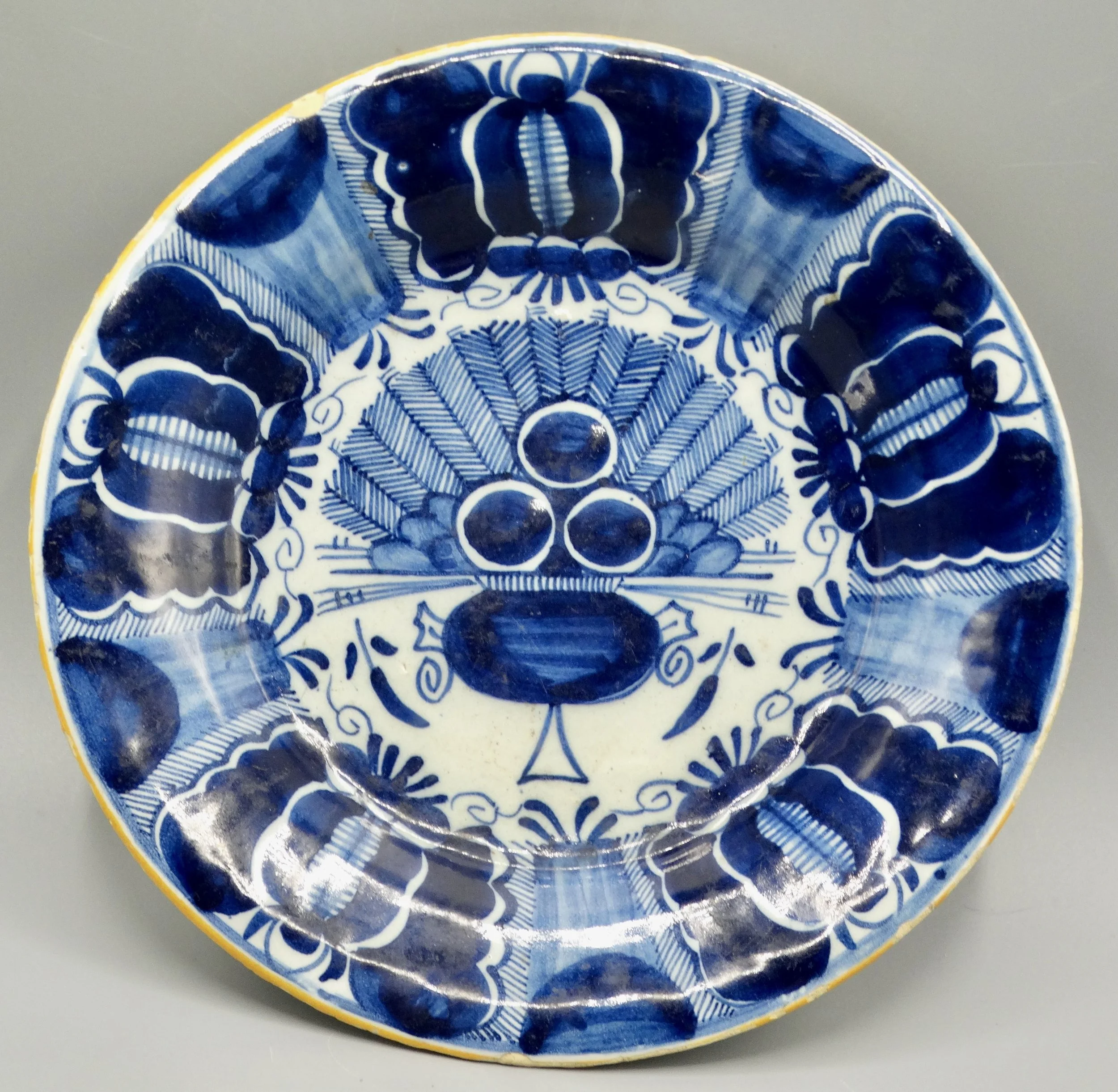 18th-century Dutch Delftware peacock plate, hand painted in blue and white, ochre rim, Three Bells maker mark