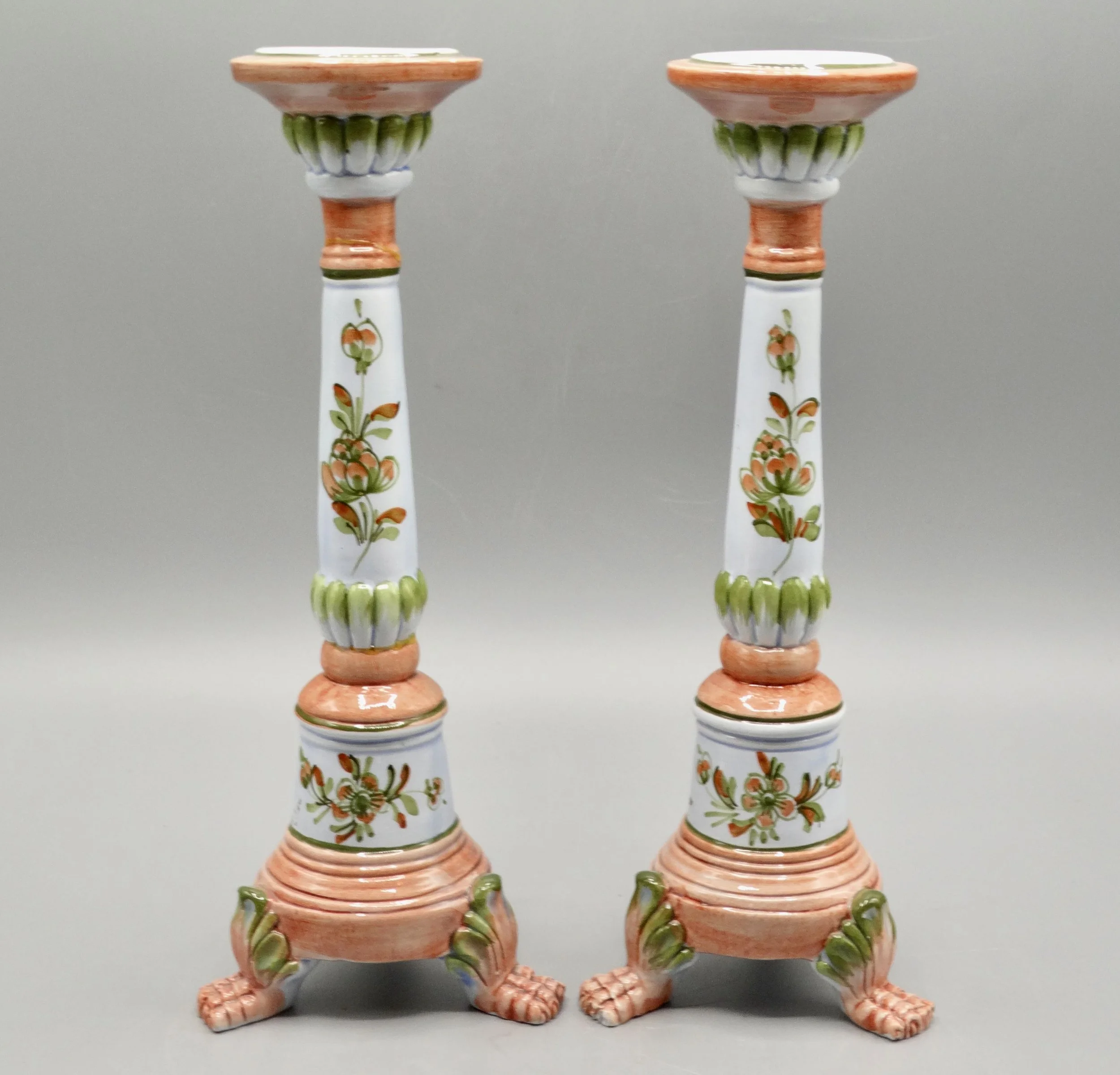 Pair of vintage Italian faience candlesticks, hand painted floral motif, raised on paw feet, mid-century Italy