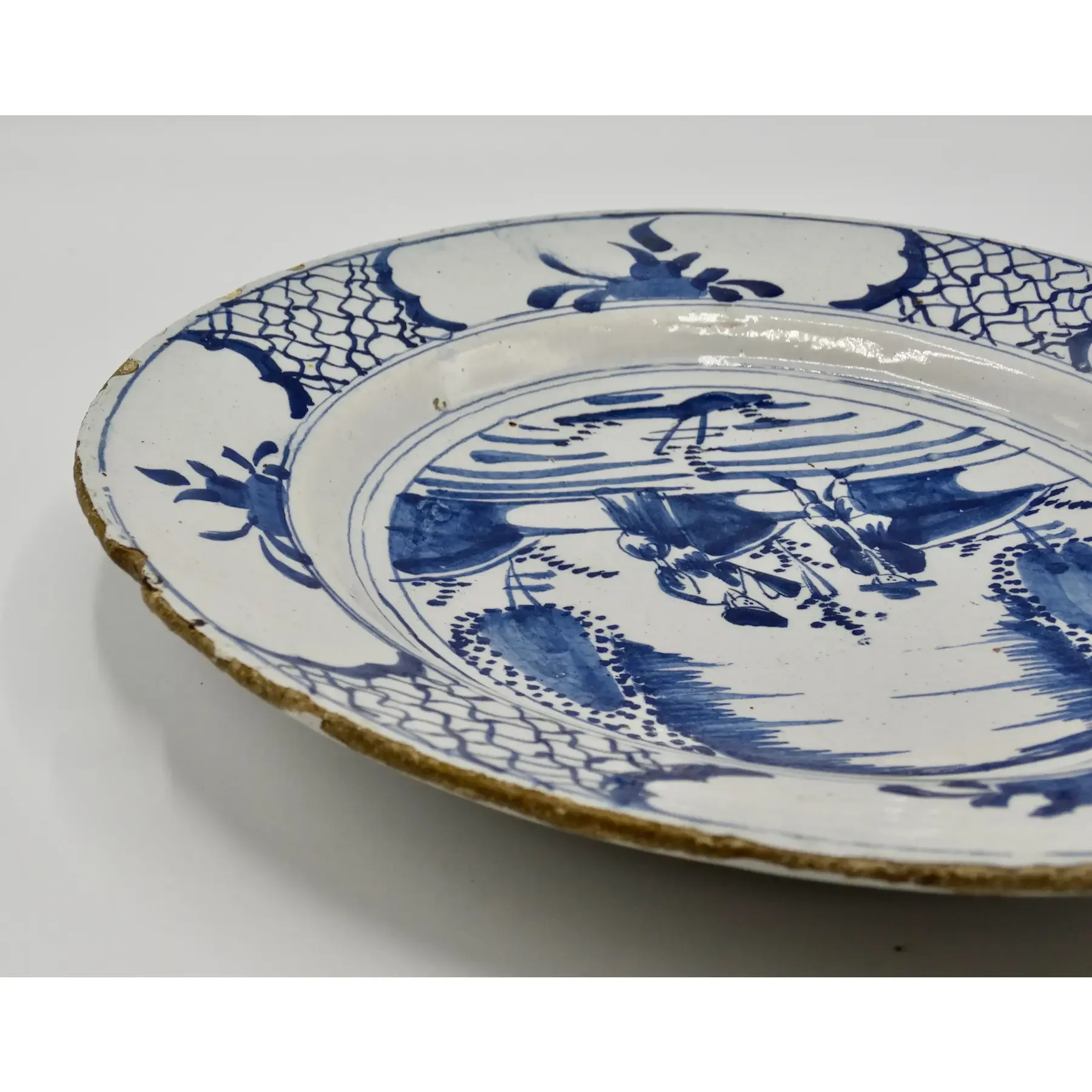 Geometric rim border on 18th century Dutch Delft charger.