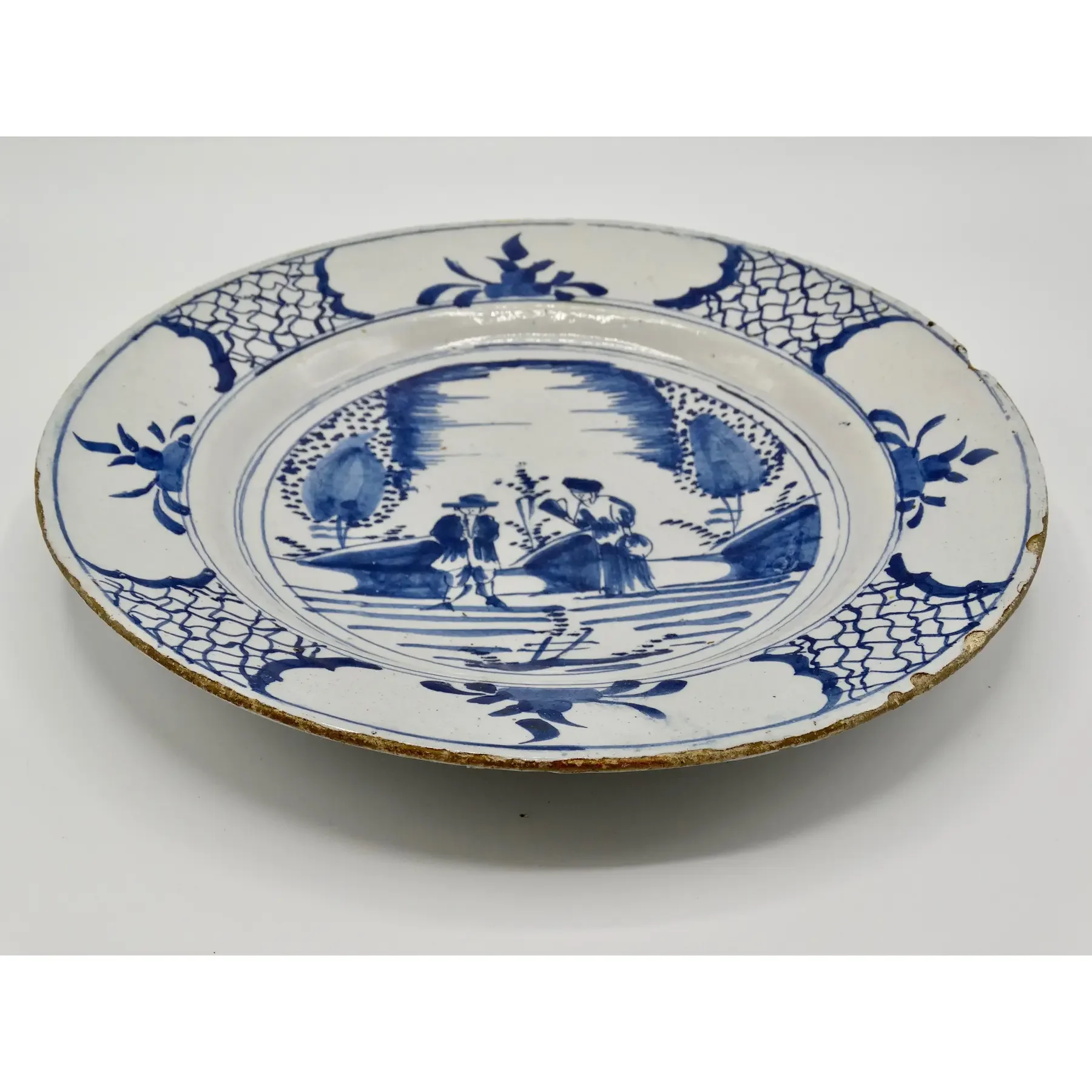 Side profile of antique Dutch Delft blue and white charger.