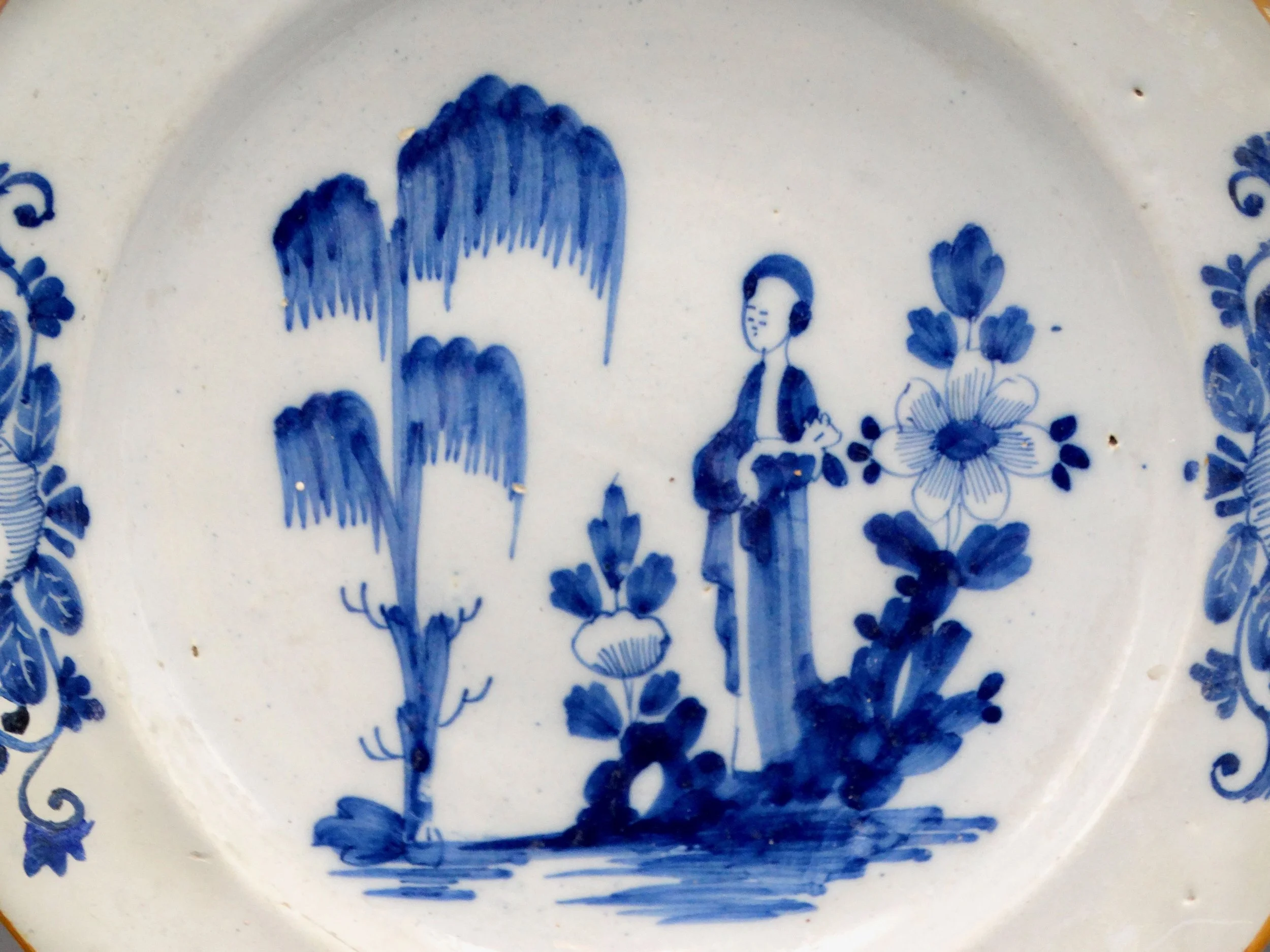Close-up of hand painted blue figural design on 18th-century Dutch Delft “Lange Lijs” charger.