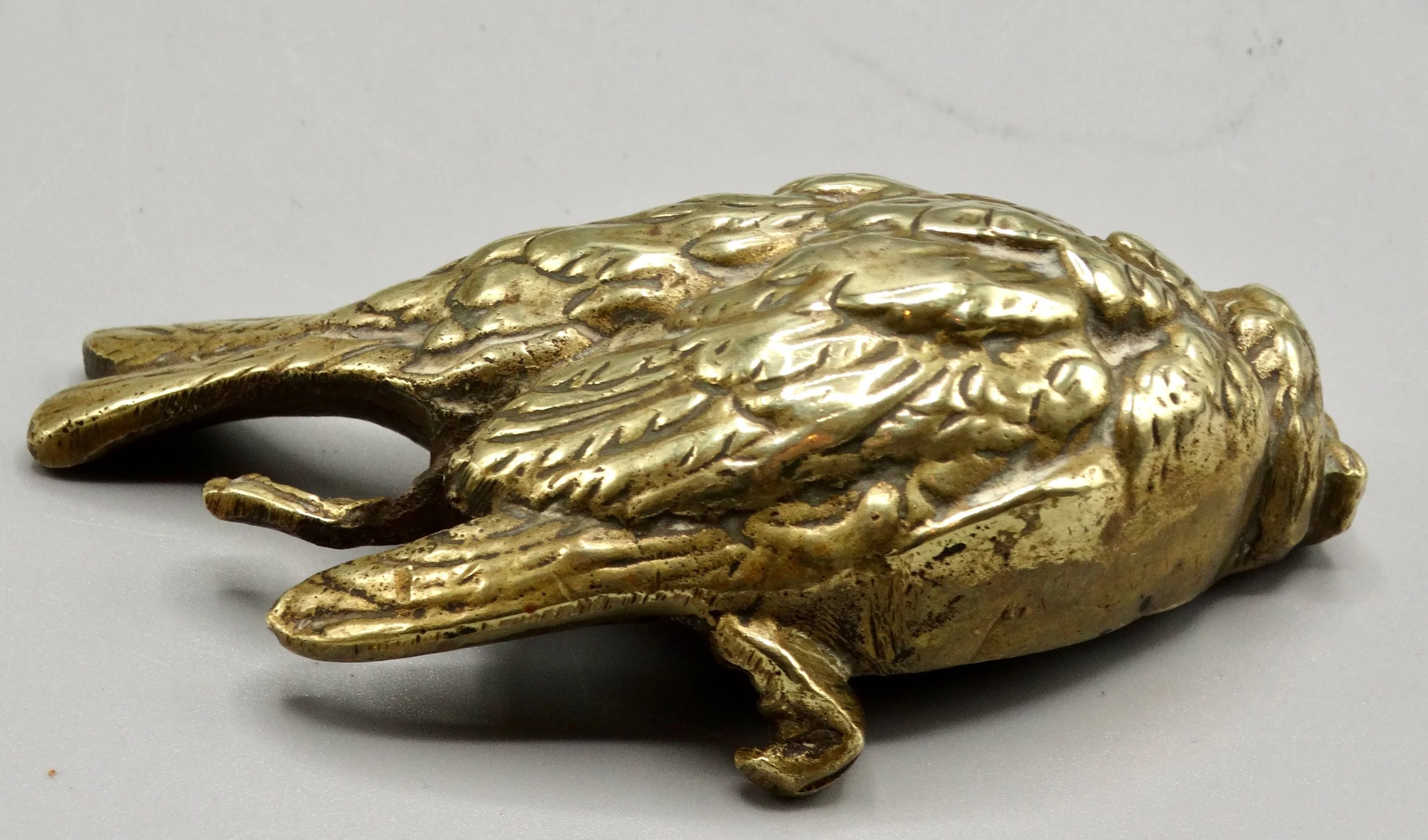 Close-up of gilt bronze Comoléra sparrow sculpture showing fine feather and body detailing.
