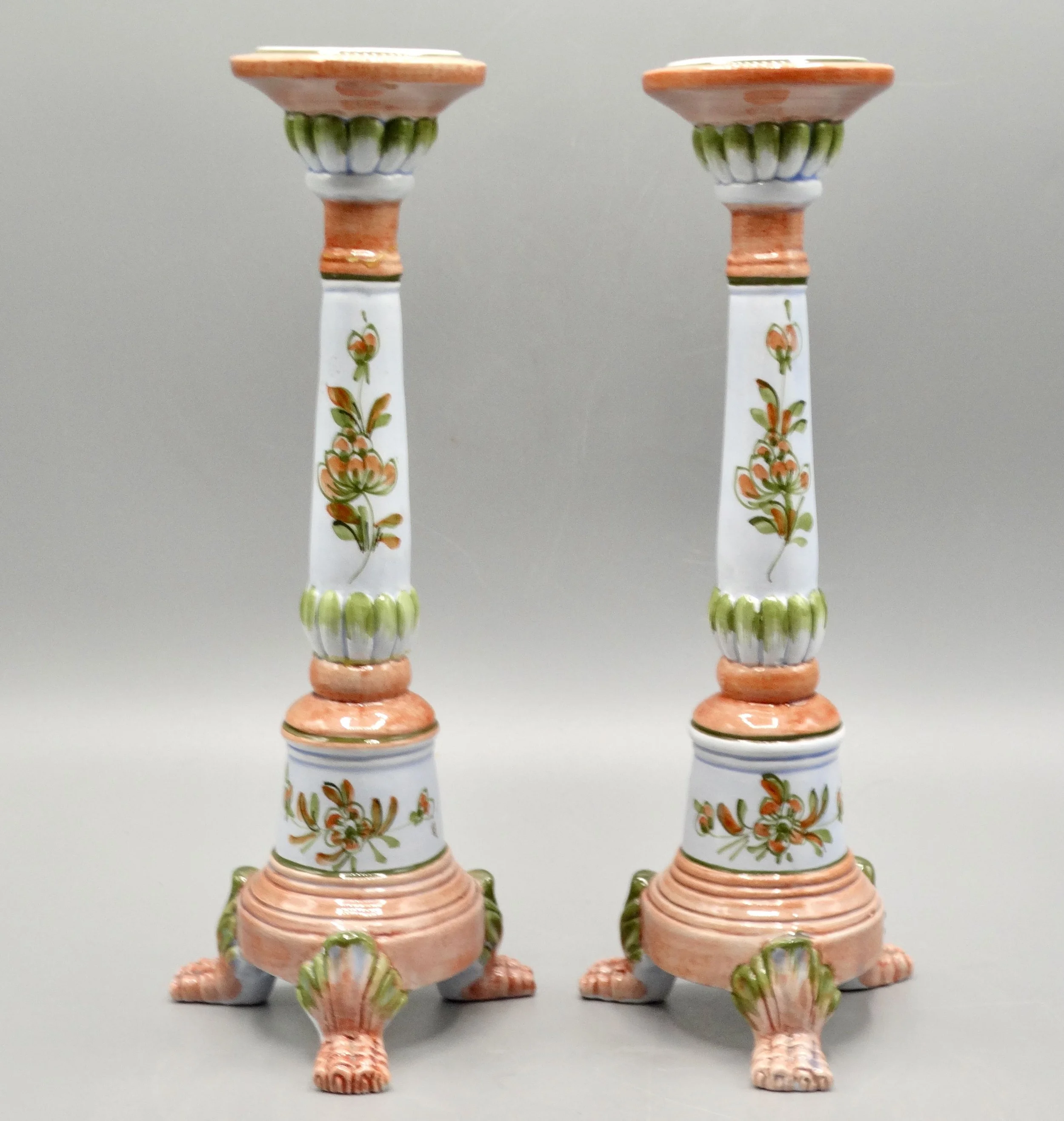 Pair of vintage Italian faience candlesticks, hand painted floral motif, raised on paw feet, mid-century Italy