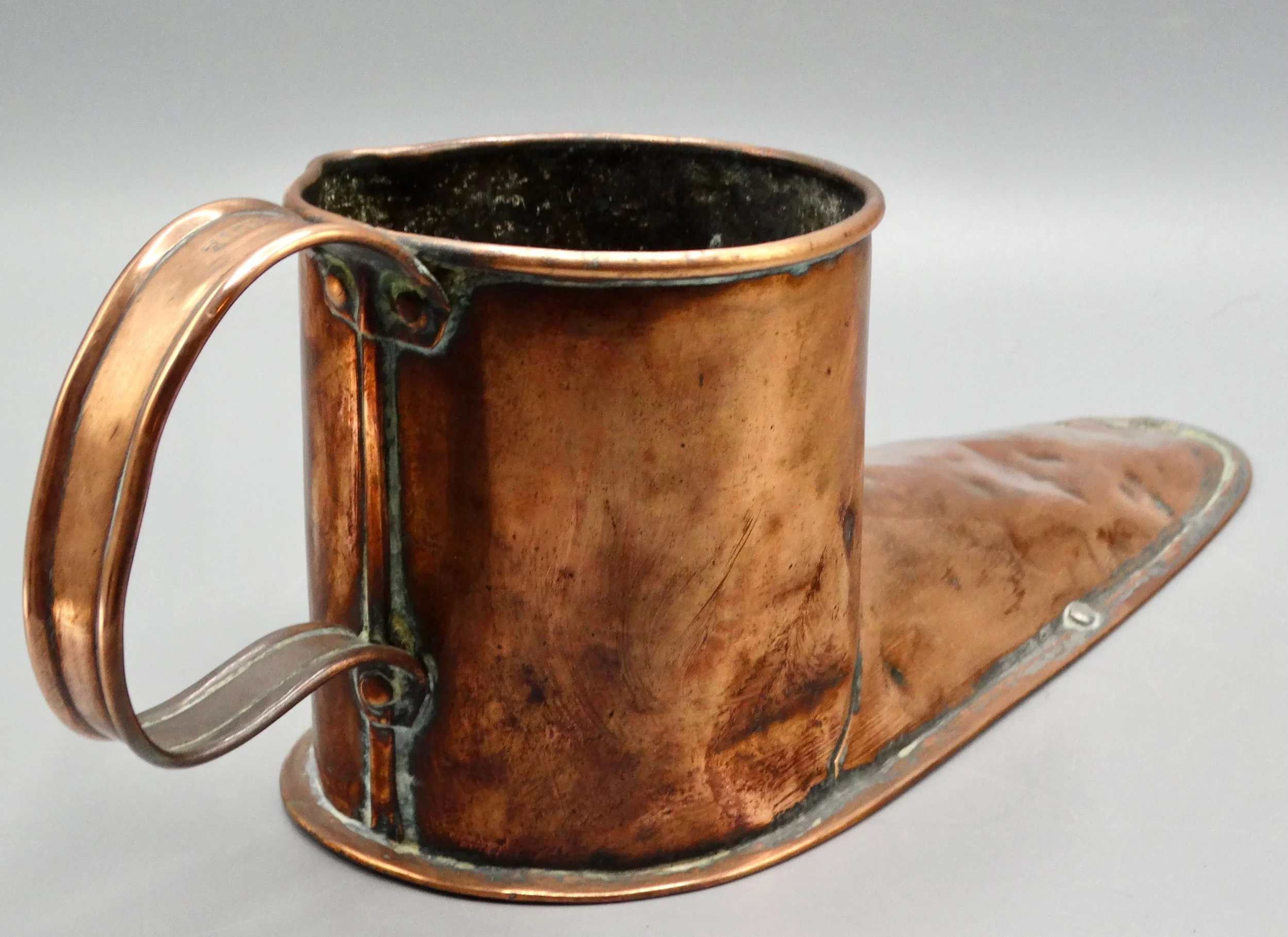 Back of 19th-century English copper boot ale warmer, showing hand formed copper craftsmanship