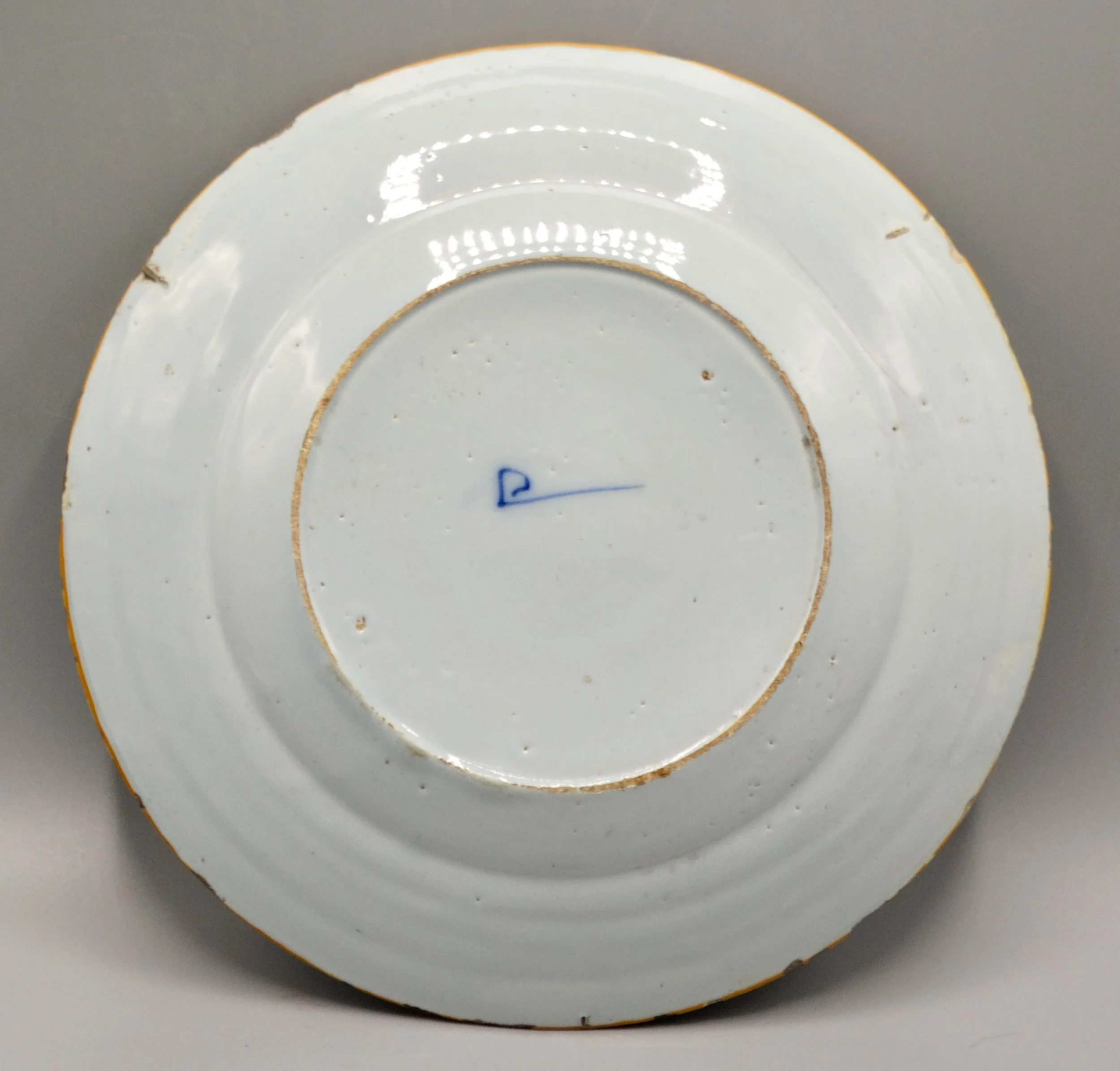 Porceleyne Bijl hatchet mark on reverse of 18th-century Dutch Delft plate, tin-glazed faience.