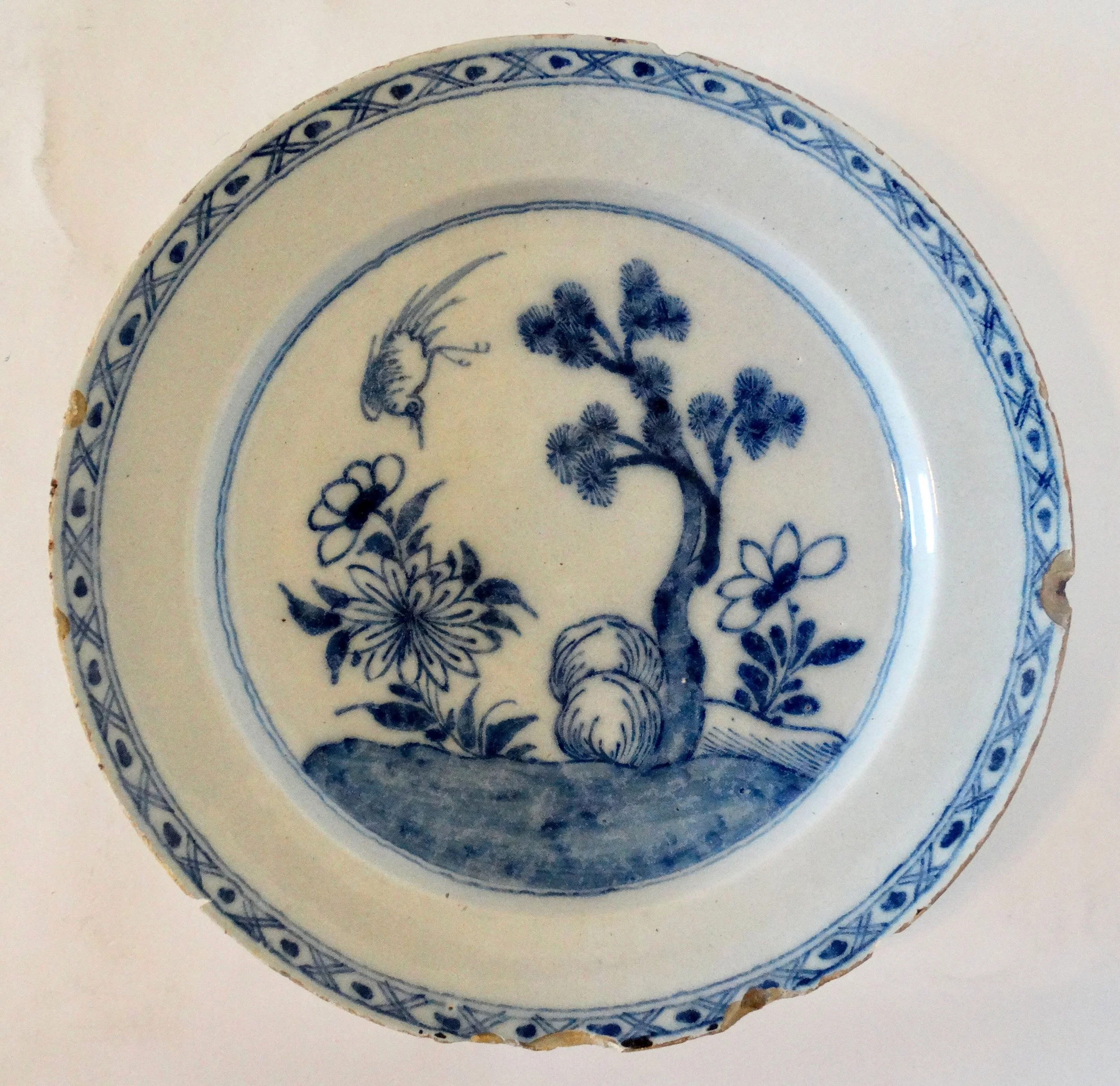Large antique Delft chinoiserie charger with hand painted blue floral and tree design.