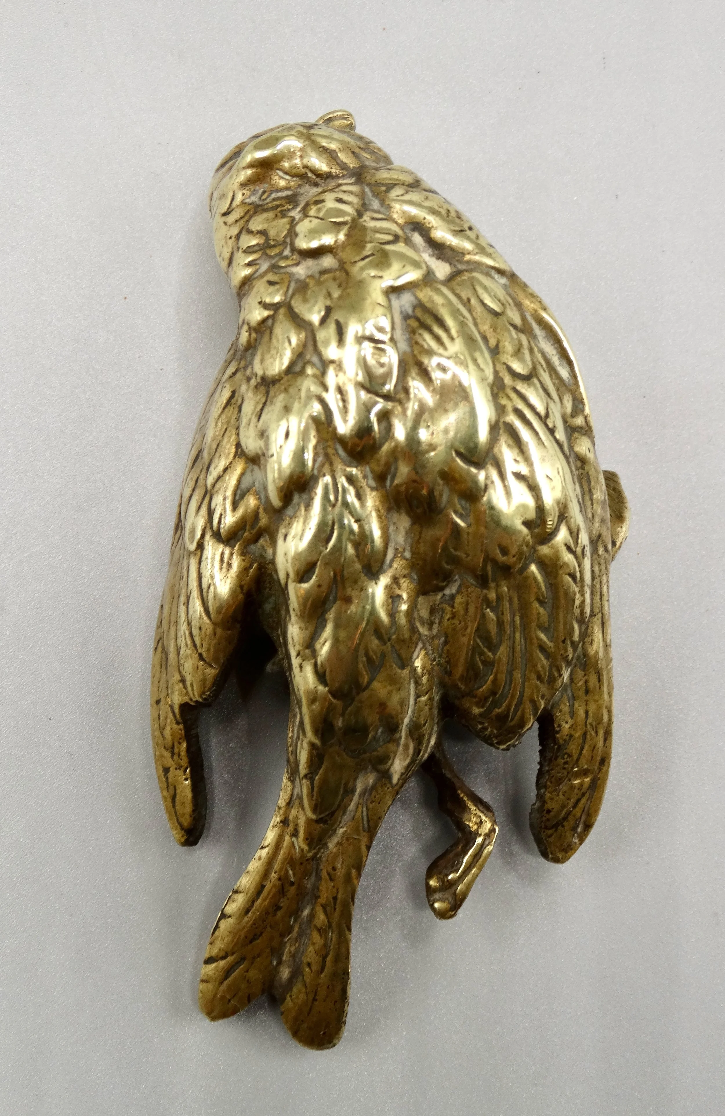 Rear view of gilt bronze Comoléra sparrow sculpture highlighting craftsmanship and patina.