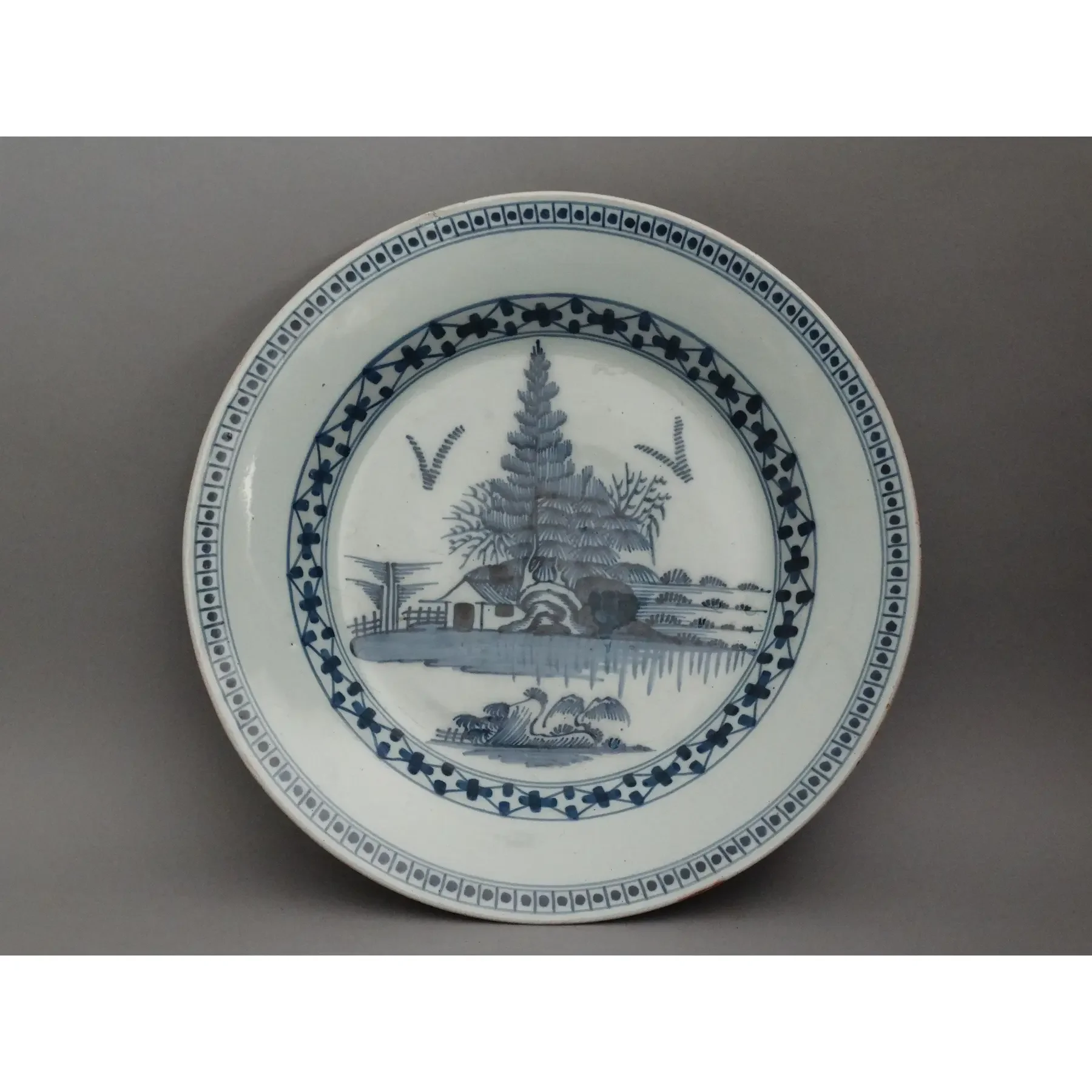 18th-century English Delft charger attributed to Lambeth with hand-painted cobalt blue chinoiserie landscape.