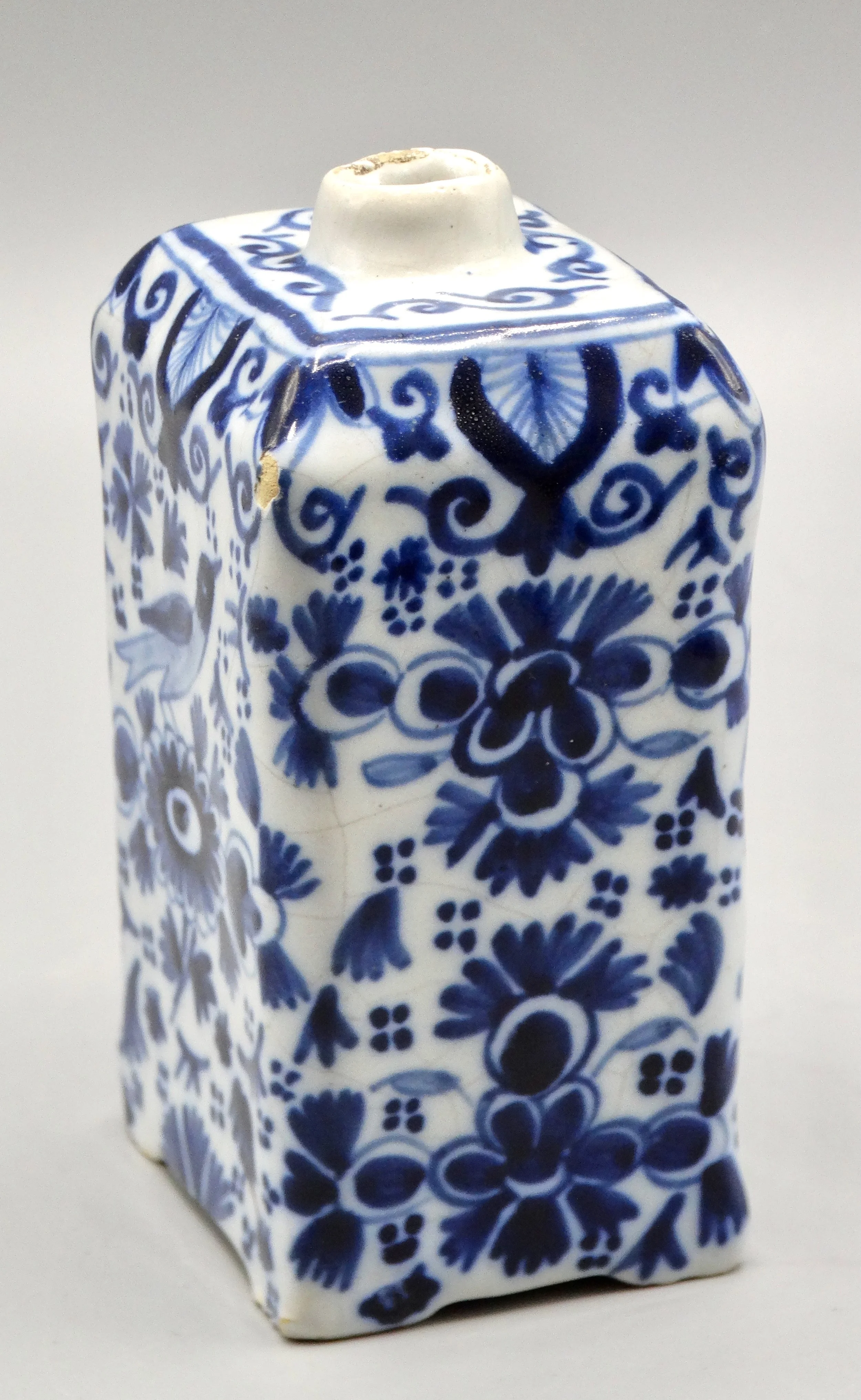 19th-century English Delft tea caddy with hand painted rampart lions, crown coat of arms, bird, and floral motifs.